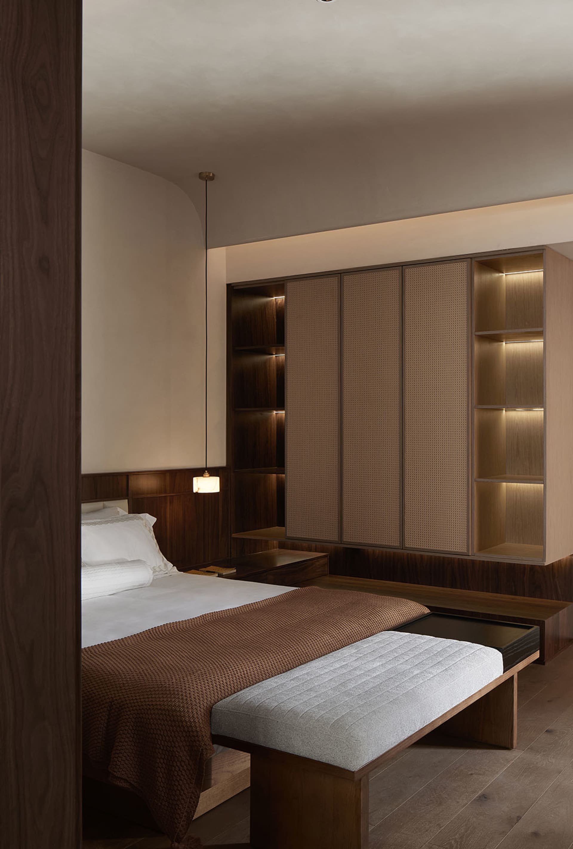 A minimalist bedroom featuring wooden furniture and a cozy atmosphere
