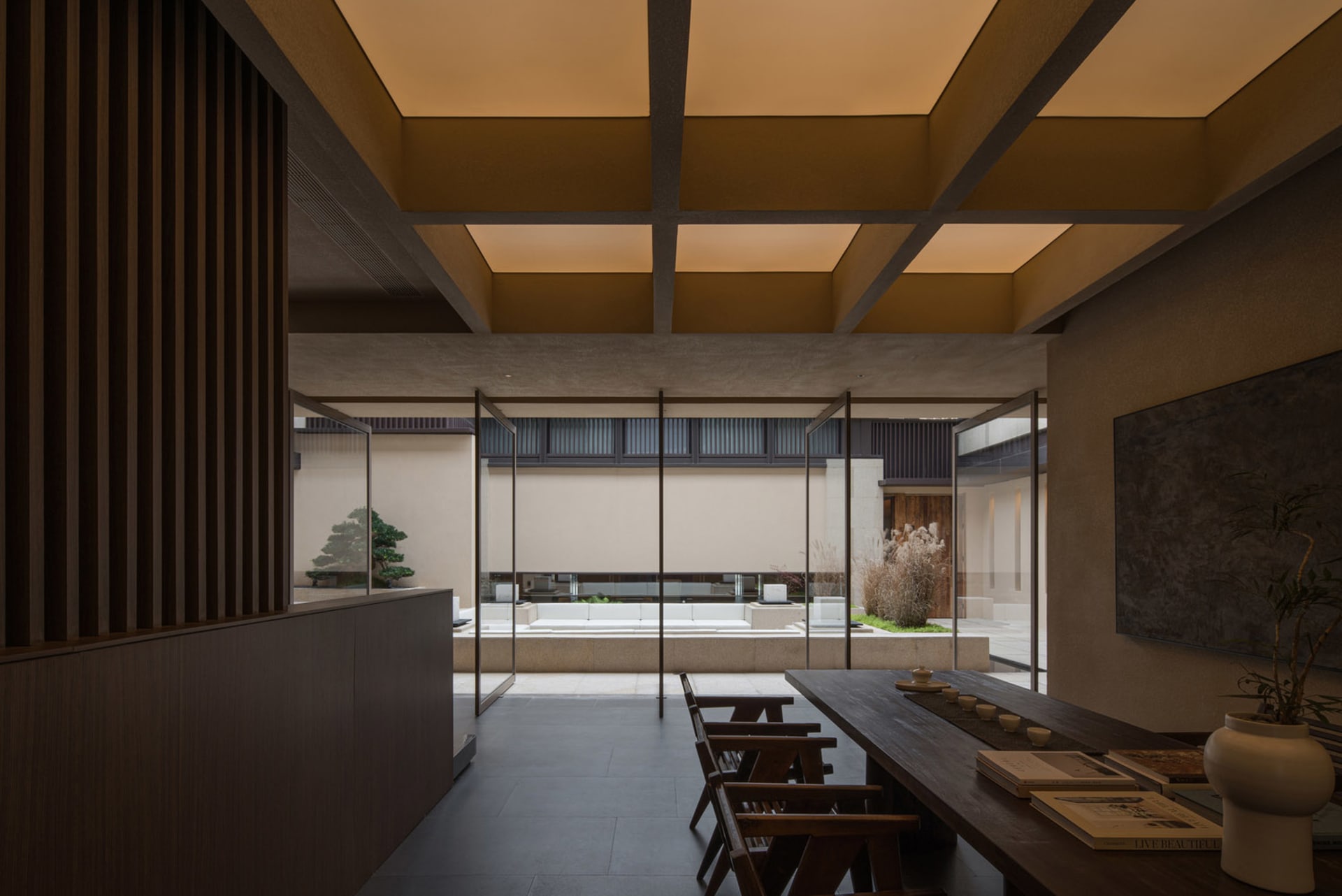Modern industrial office space with concrete, glass, and metal materials.