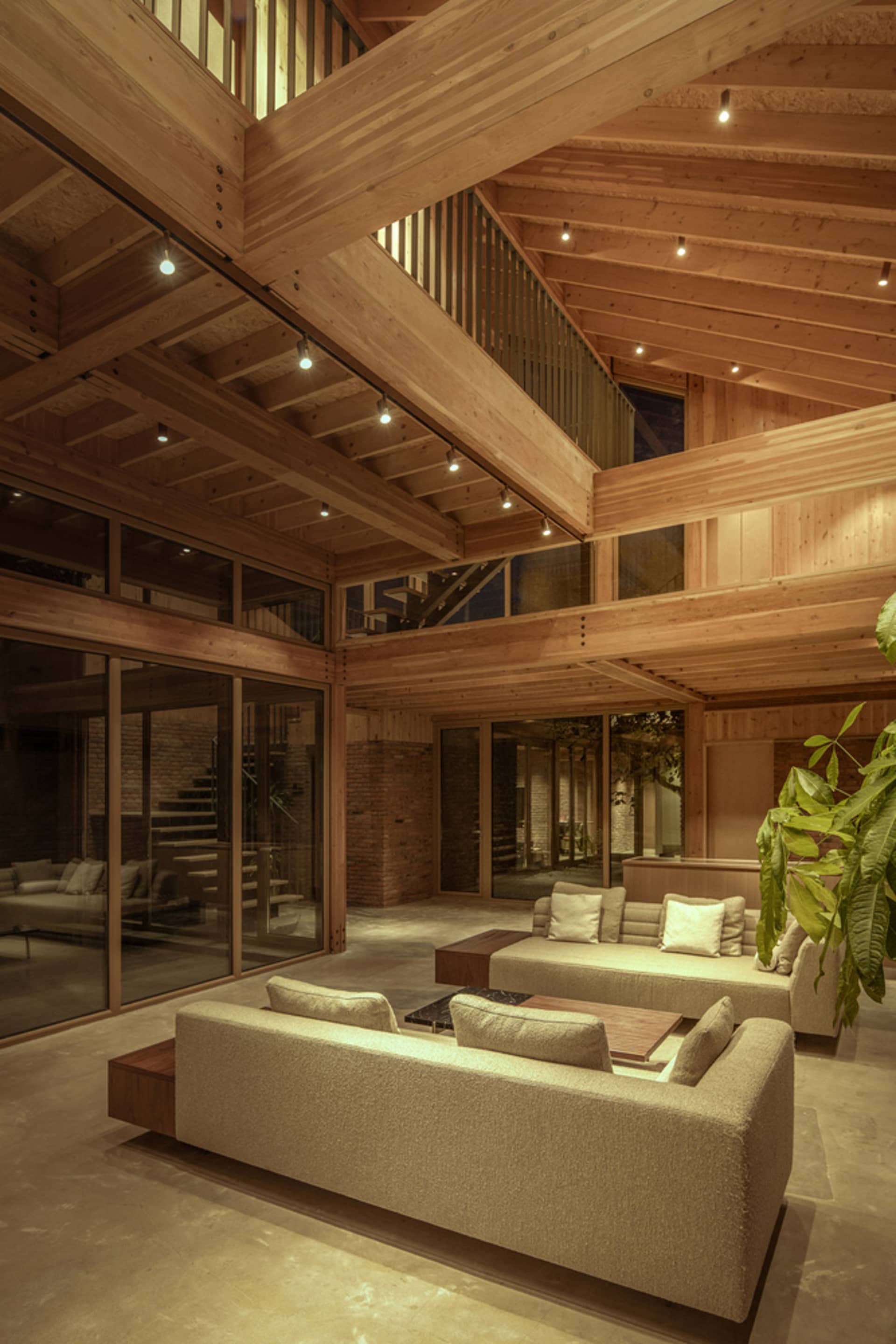 Interior view of a modern living room with wooden elements and contemporary furniture.