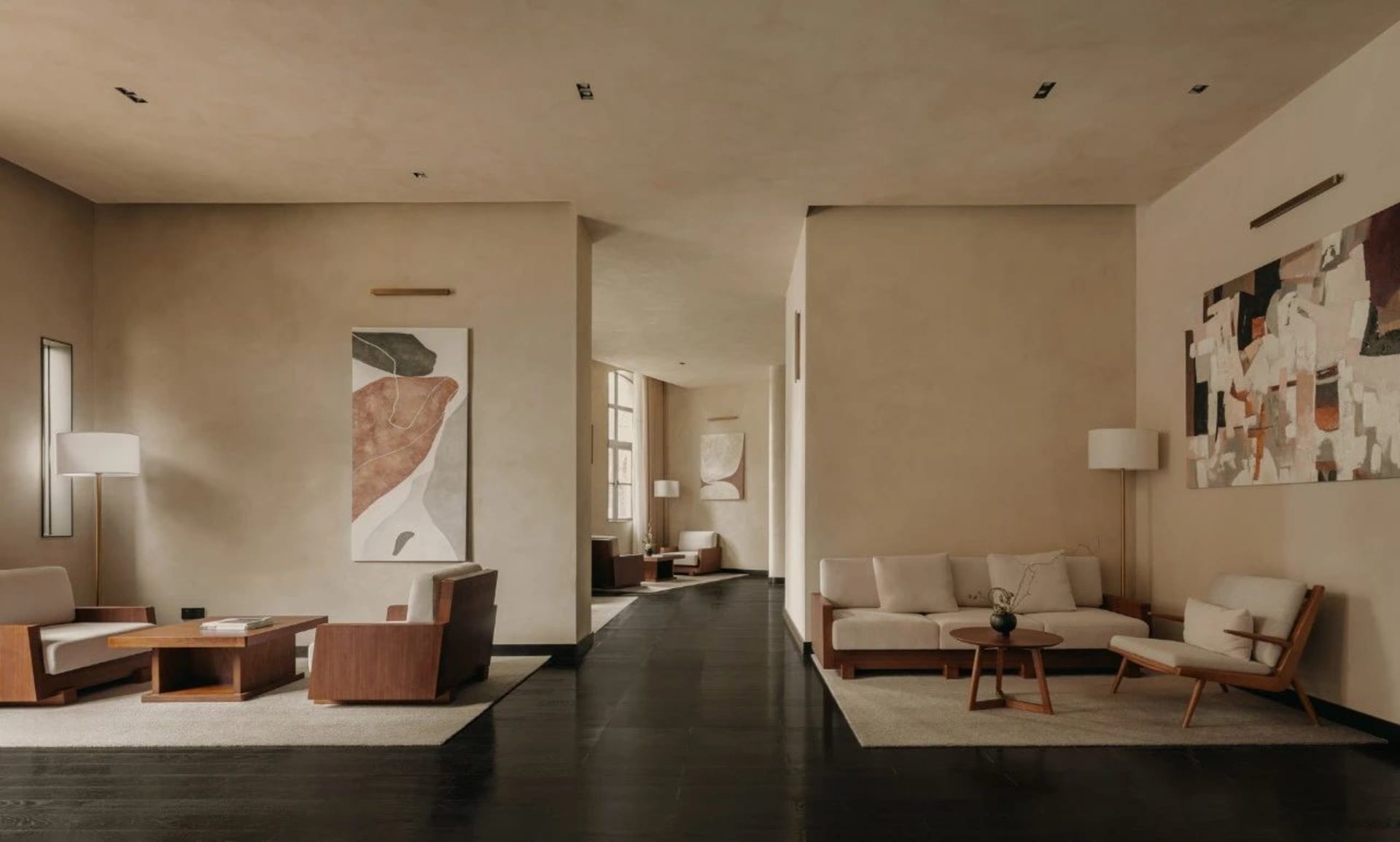 A modern living room with neutral tones, featuring minimalist furniture and abstract art.