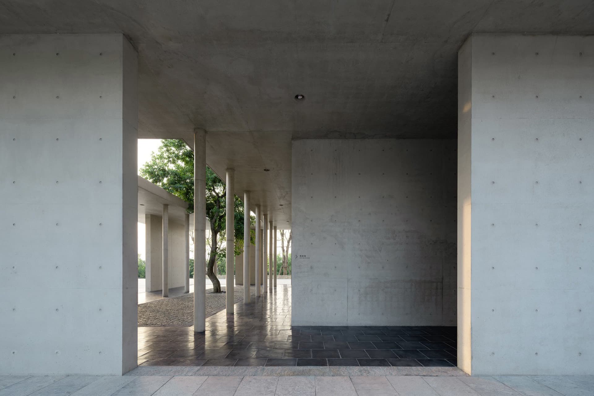 A modern outdoor veranda constructed from concrete, featuring clean lines and a minimalist design.