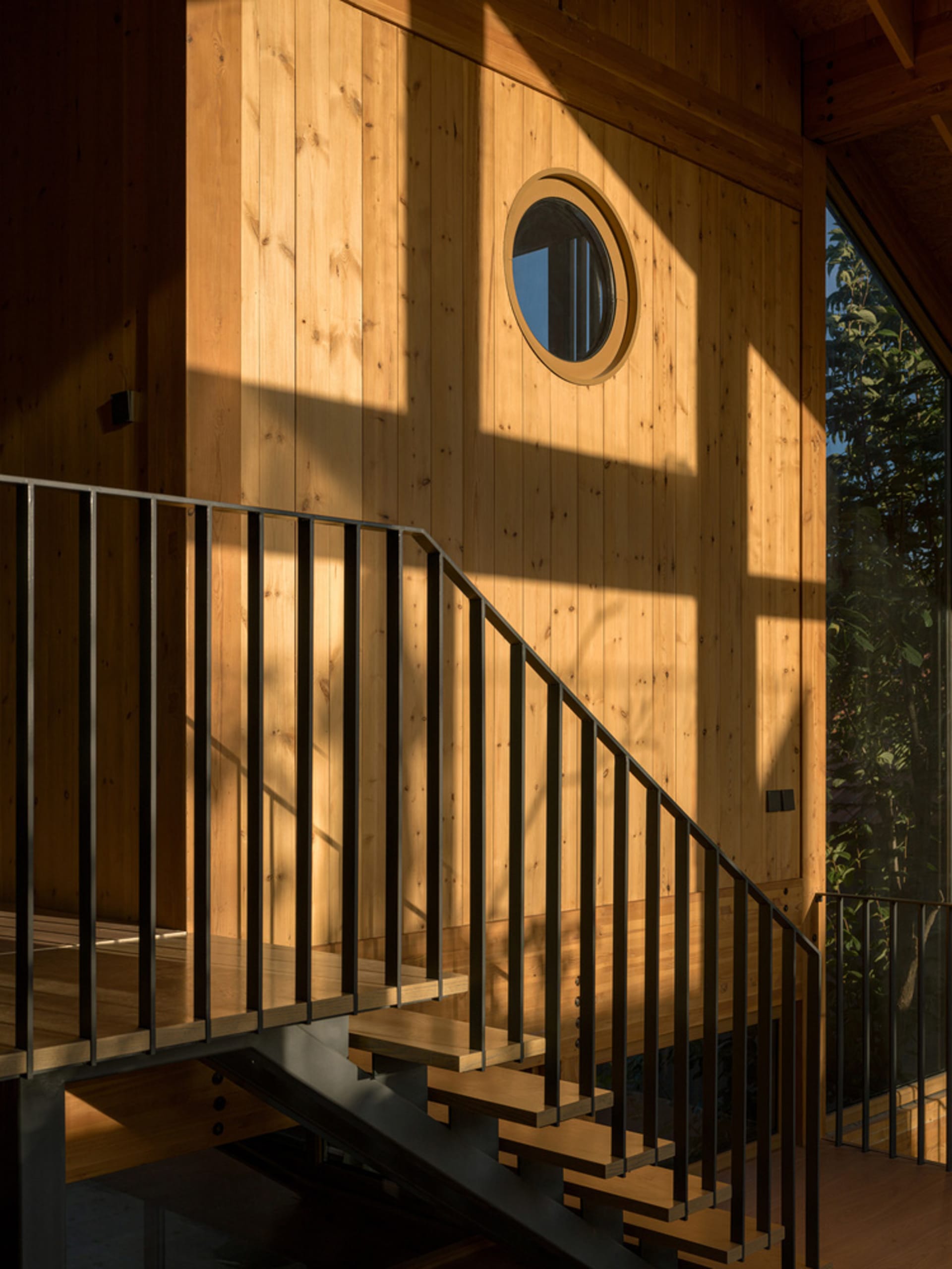 Modern staircase with wooden steps and black metal railings