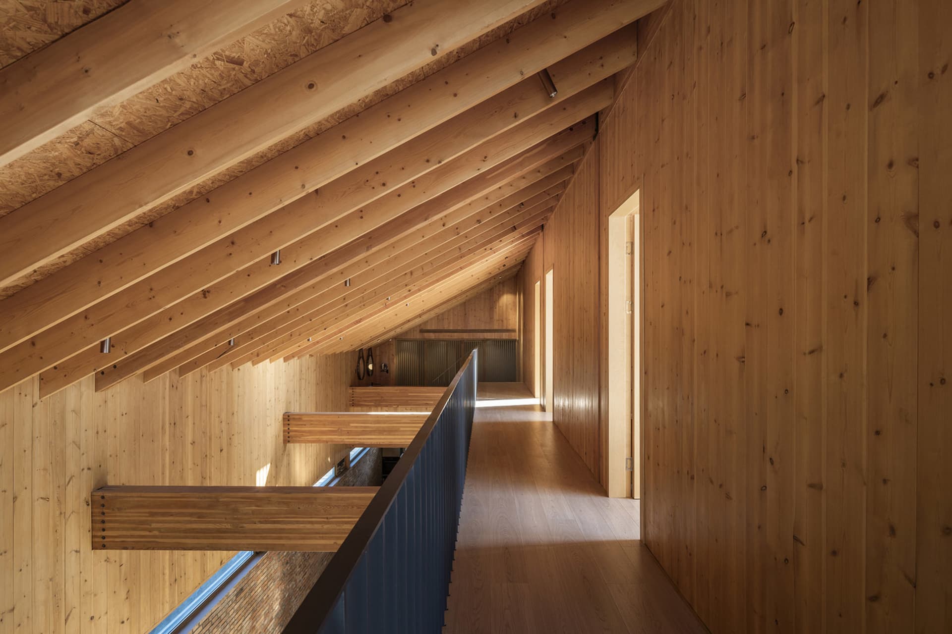 Modern interior design featuring wooden walls and floors.