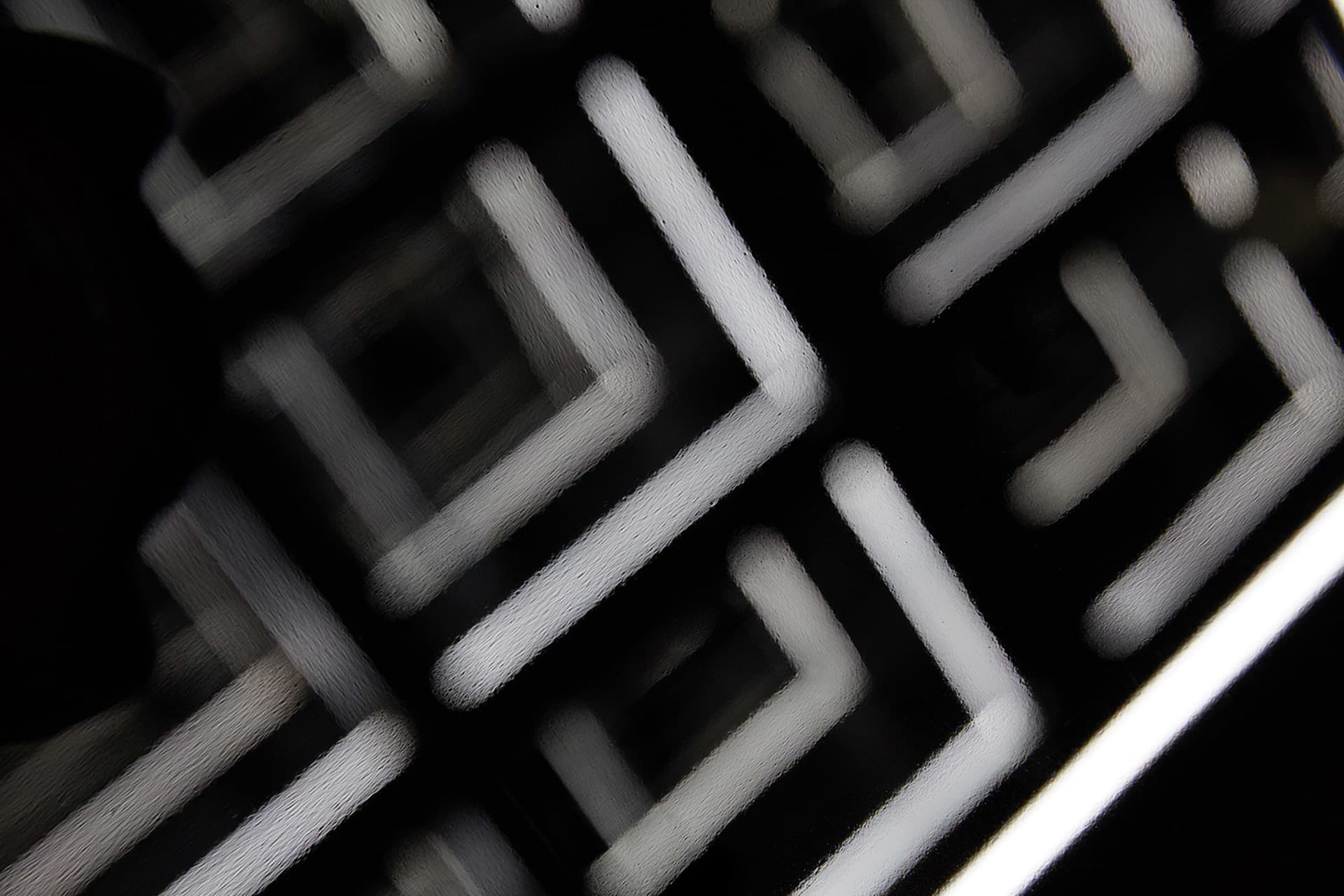 A glass floor plan showcasing an abstract geometric grid pattern.