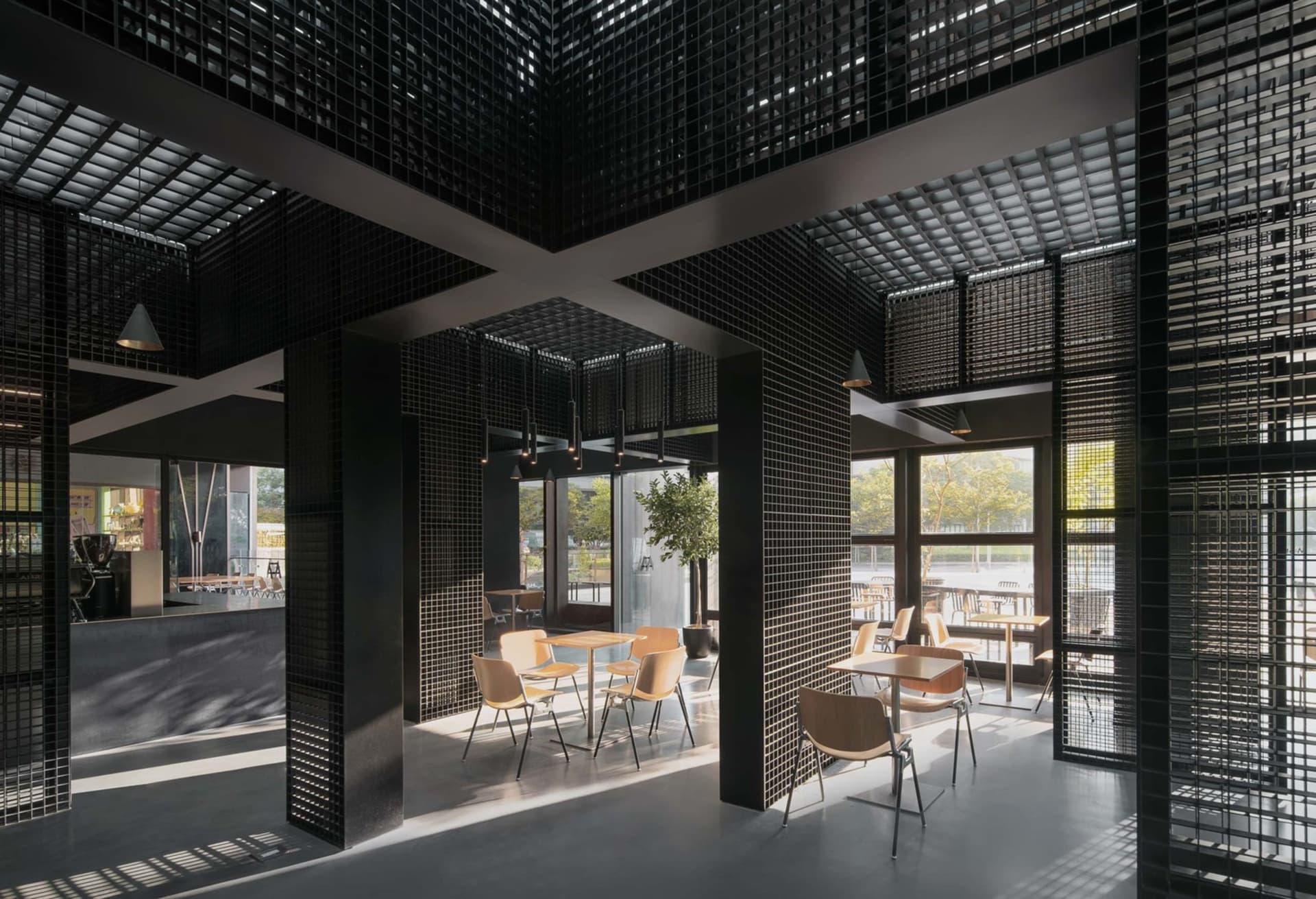 Modern industrial cafe interior with concrete, glass, and wood details.