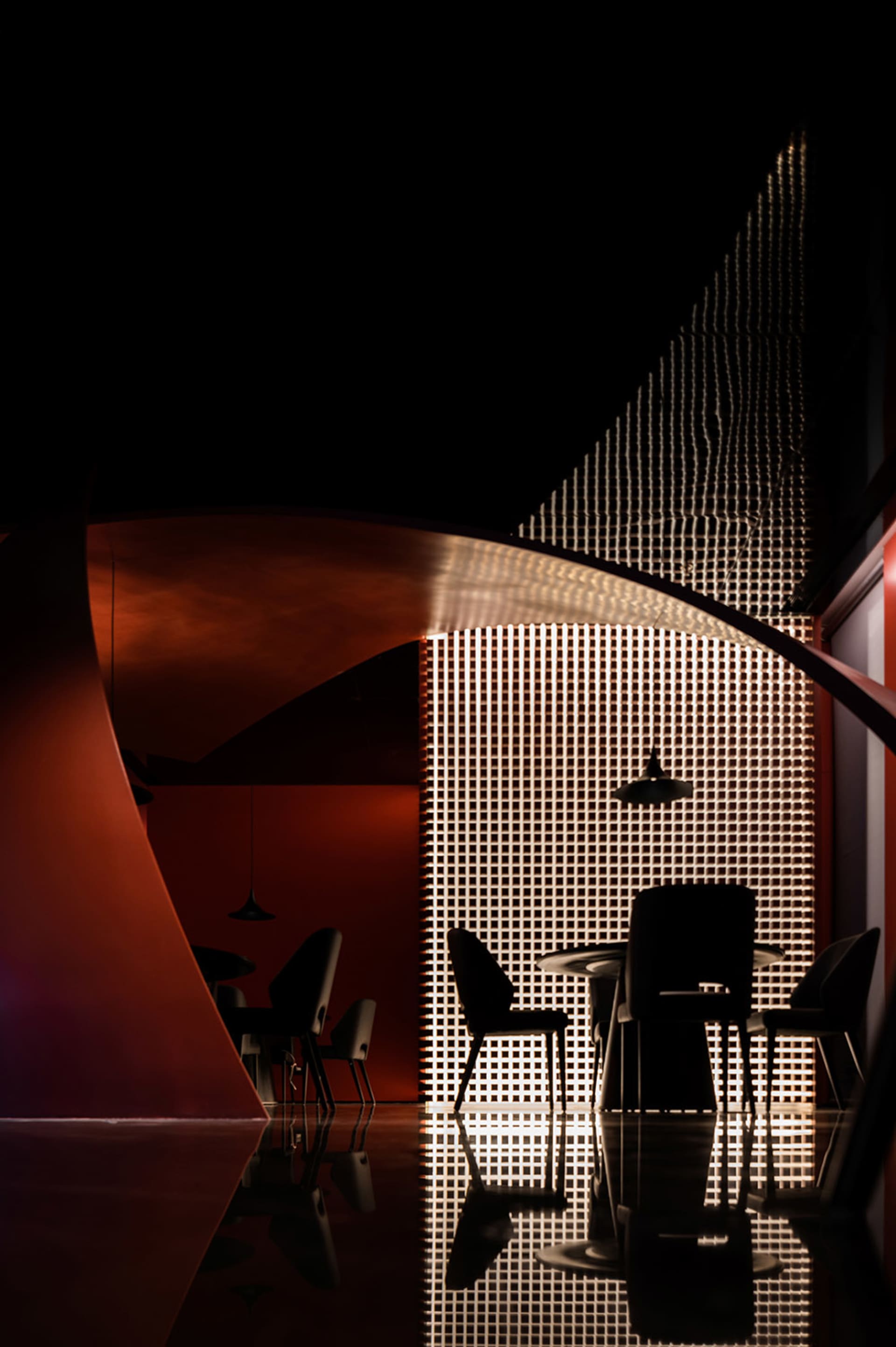Metallic surfaces and industrial design elements create a contemporary restaurant interior.