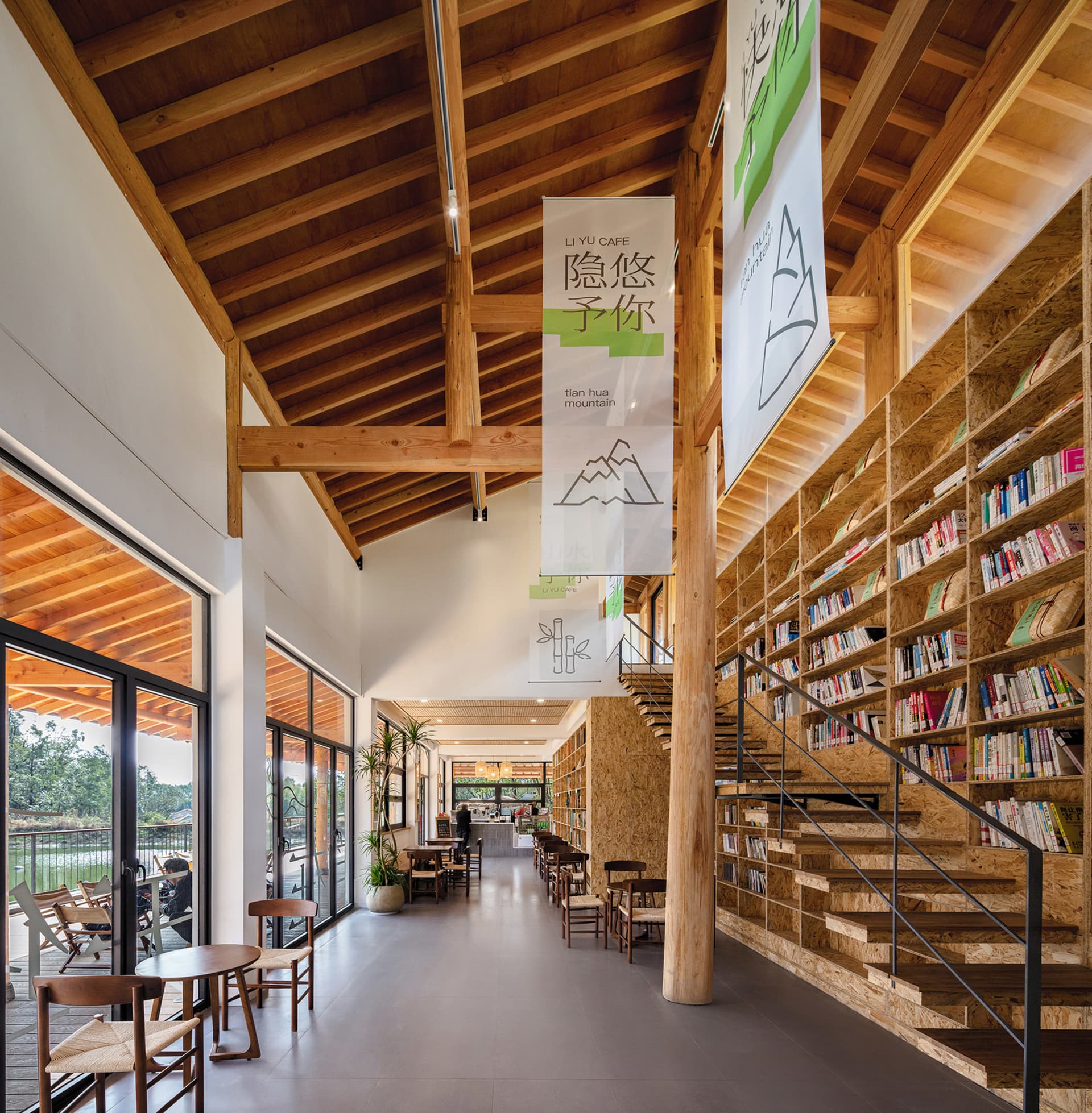 A modern, industrial-style library with an extensive collection of books and a warm, wooden interior.