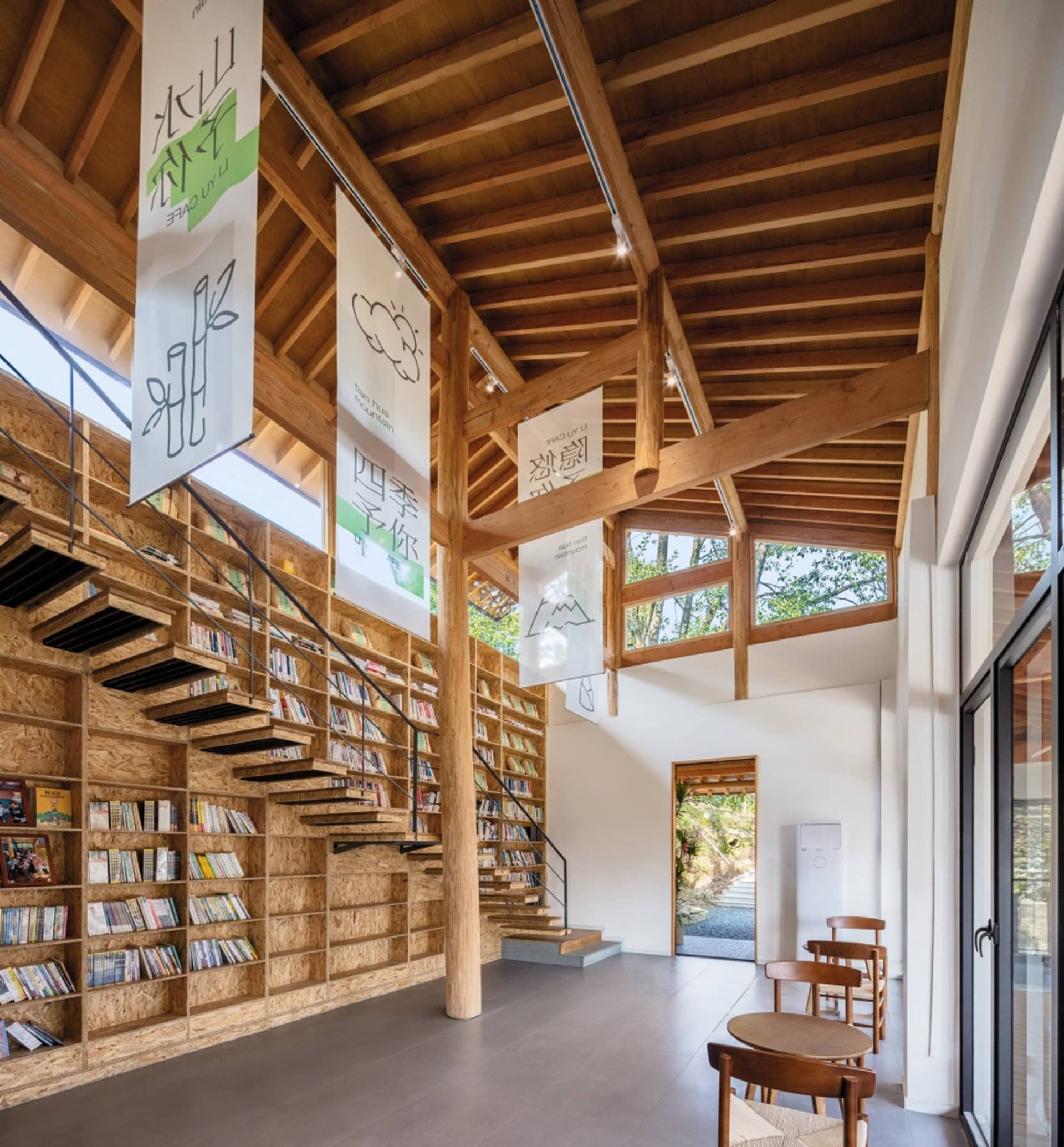 A minimalist library interior with wooden shelves and stairs.