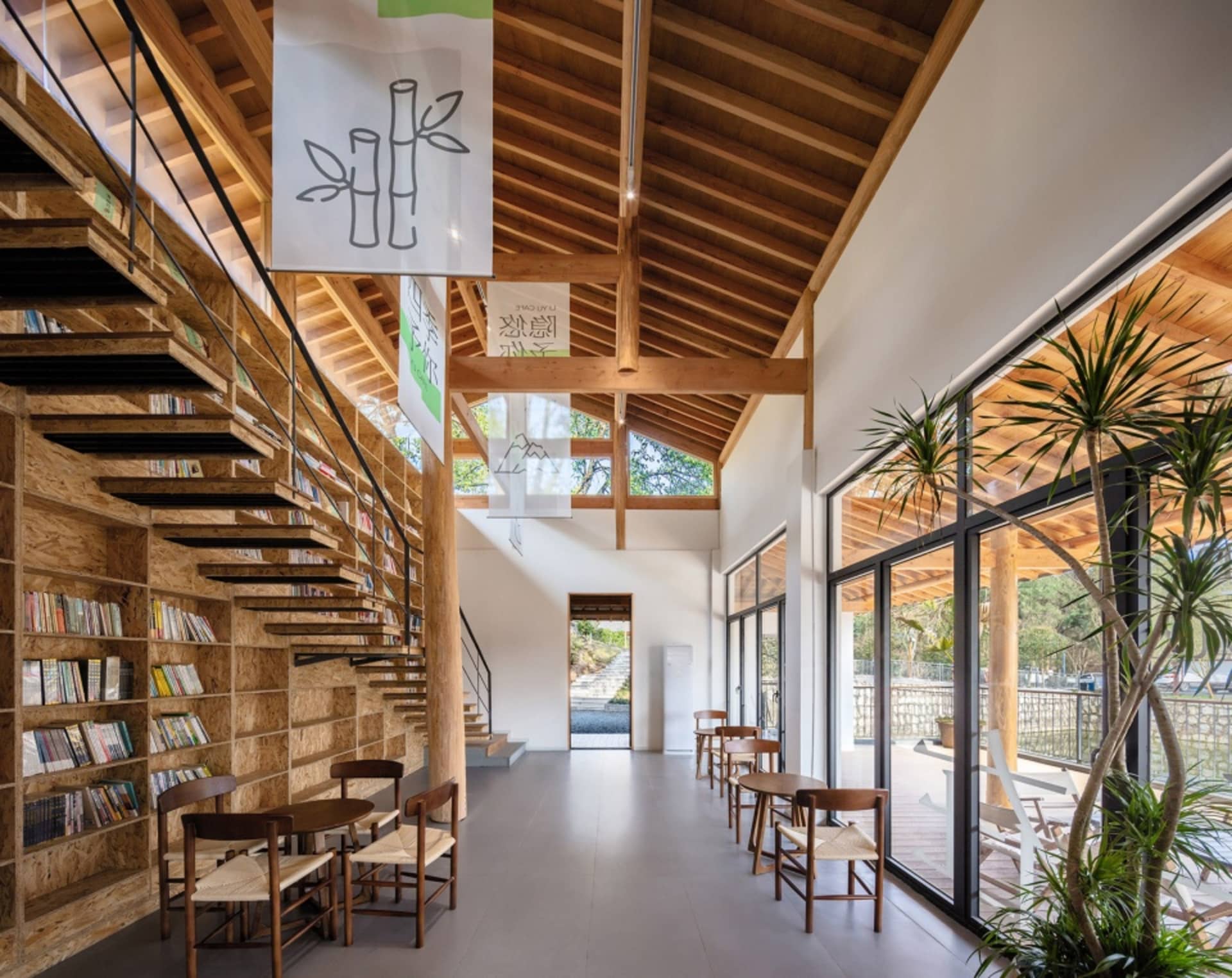 Modern library interior featuring wooden shelves and tables with a mix of reading materials.