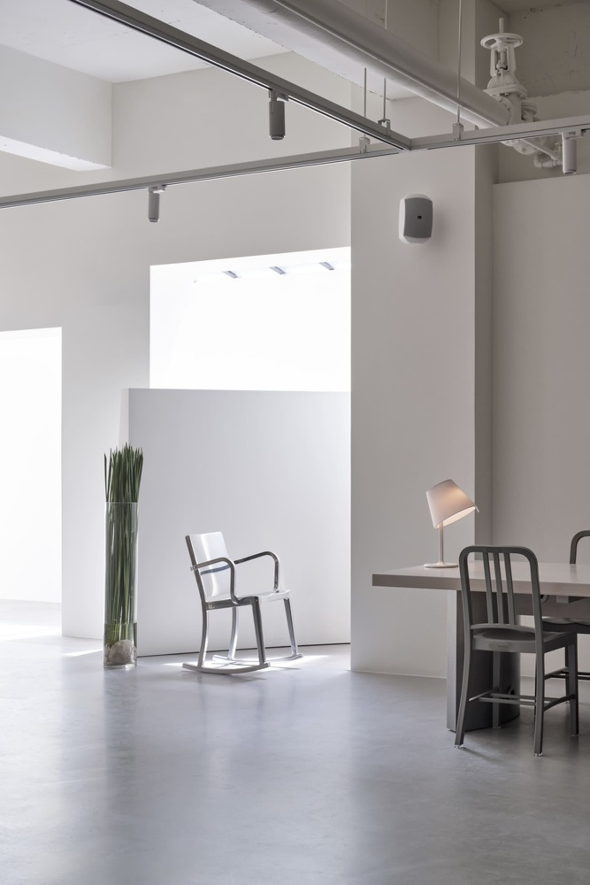 Modern minimalist office interior with concrete flooring and minimalist furniture.