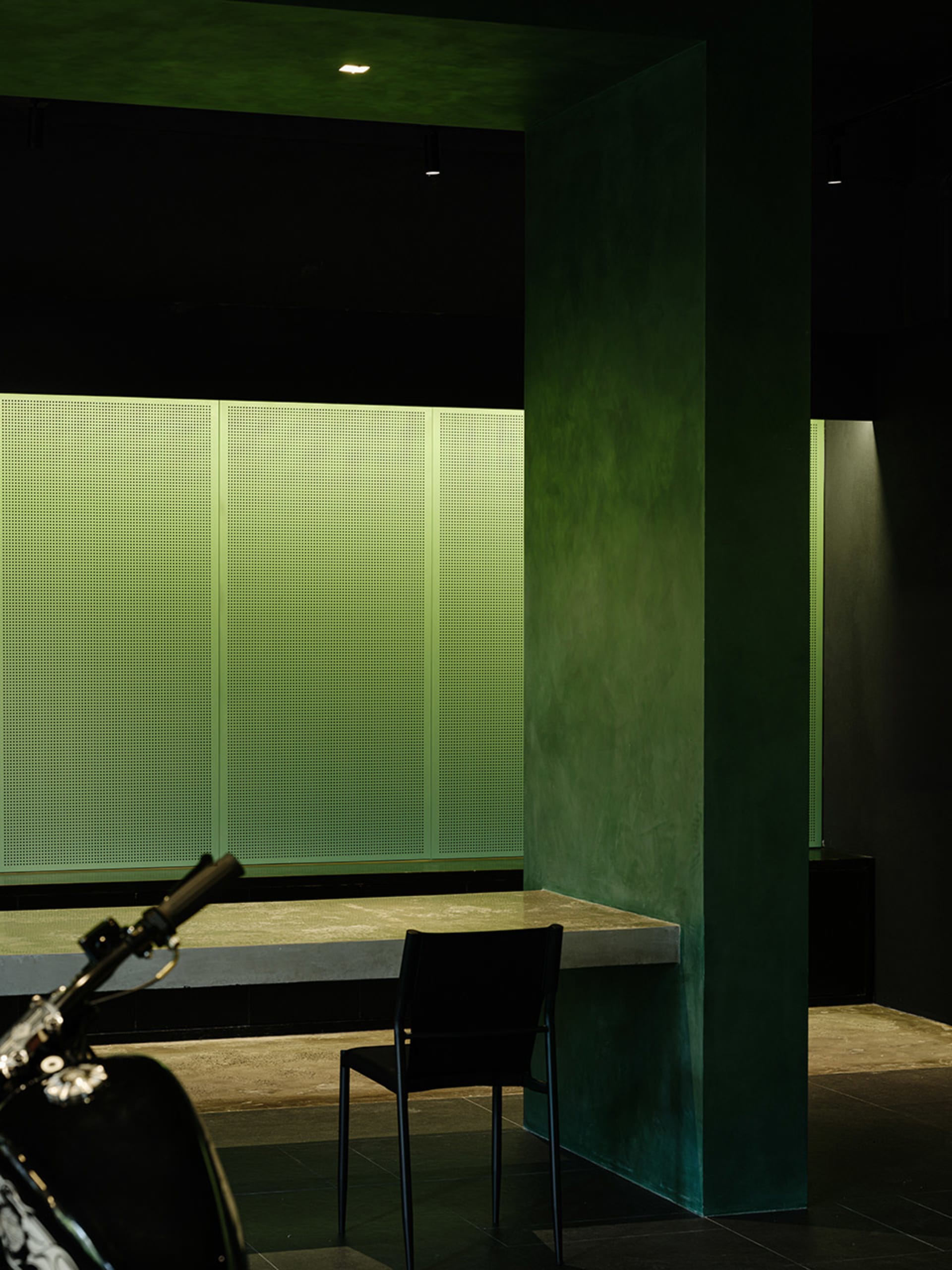 A modern minimalist interior with a concrete ceiling in a presentation room setting.