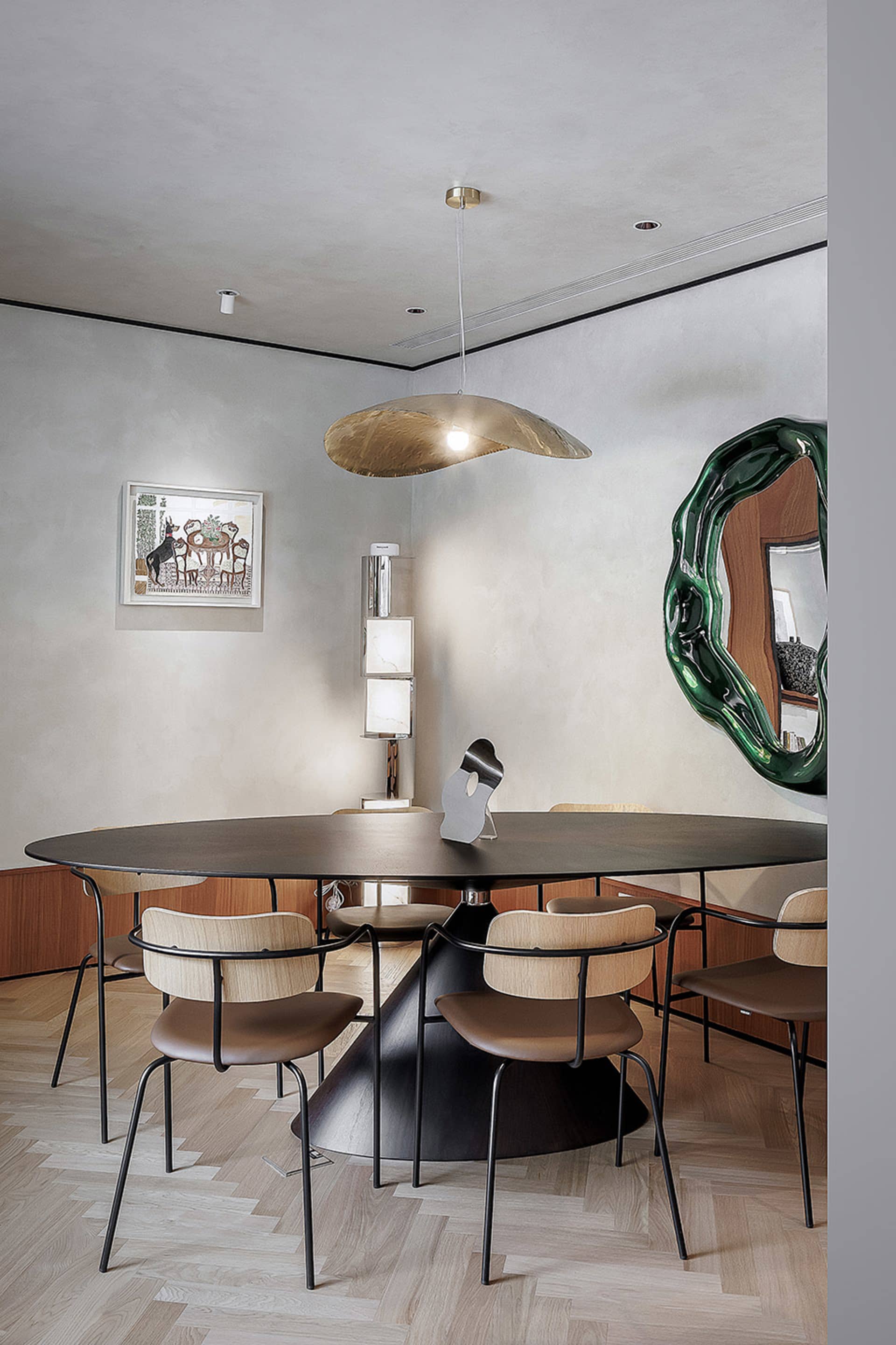 Modern dining room with a metal and wooden table, chairs, and pendant light.