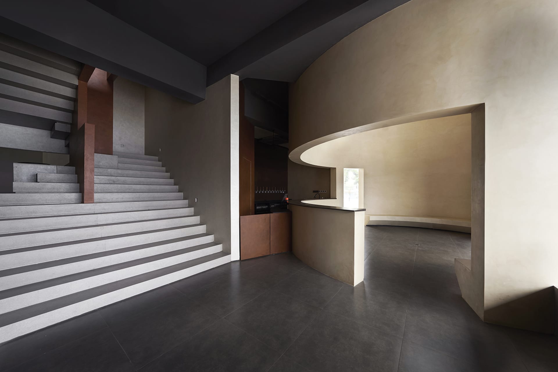 Interior design featuring modern industrial elements with concrete materials.