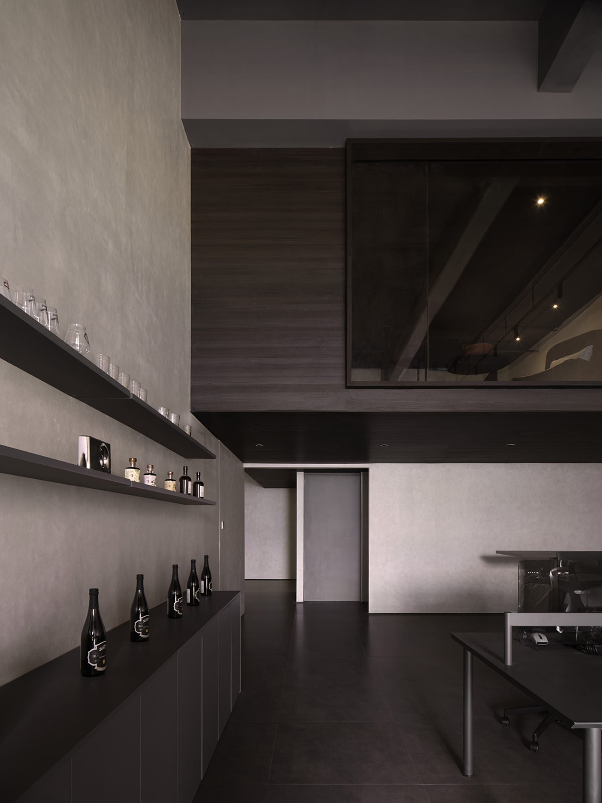 Modern industrial office space with concrete walls and metal accents.