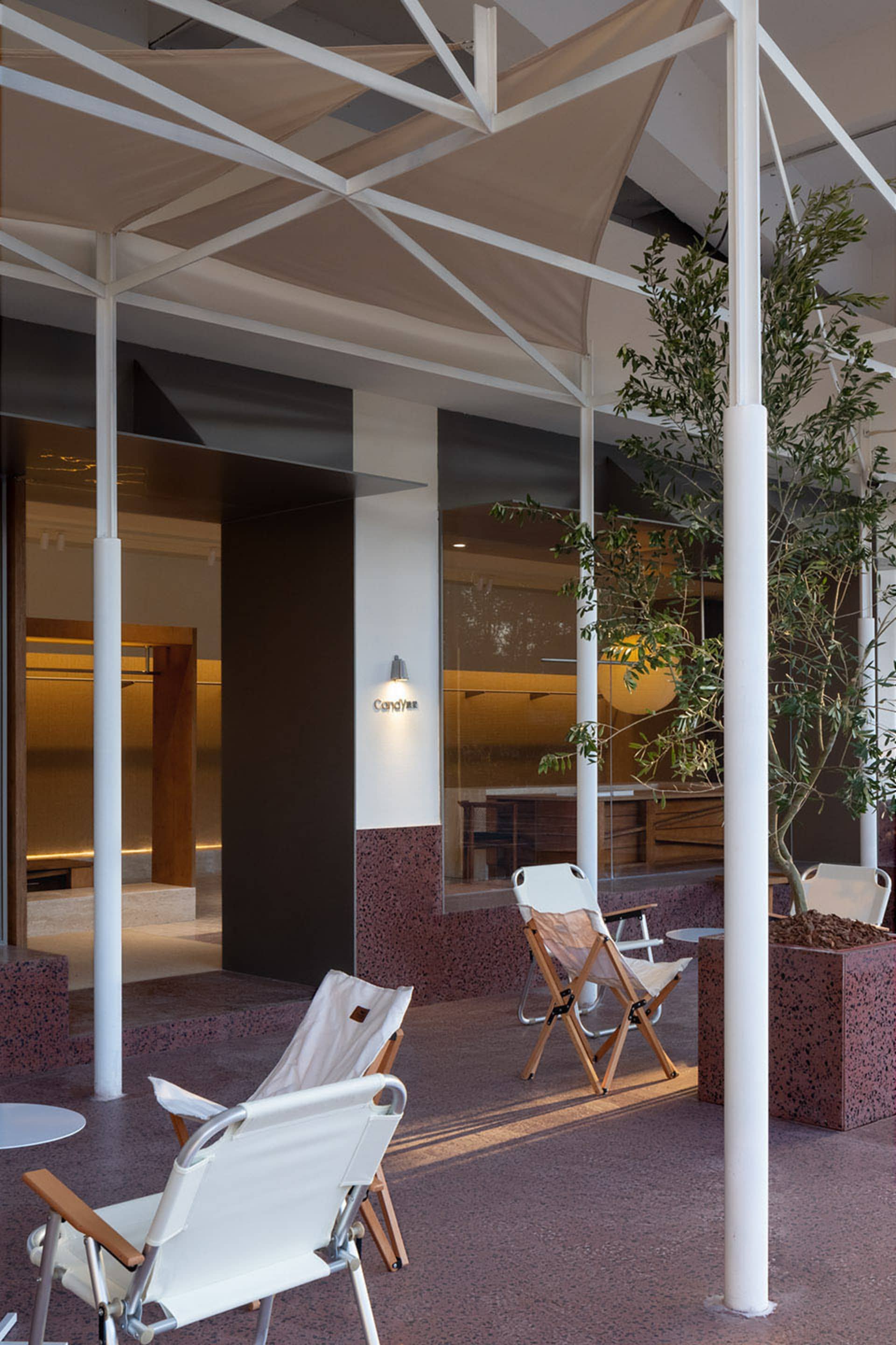 Modern lobby interior design featuring concrete construction, minimalist furniture, and natural light.