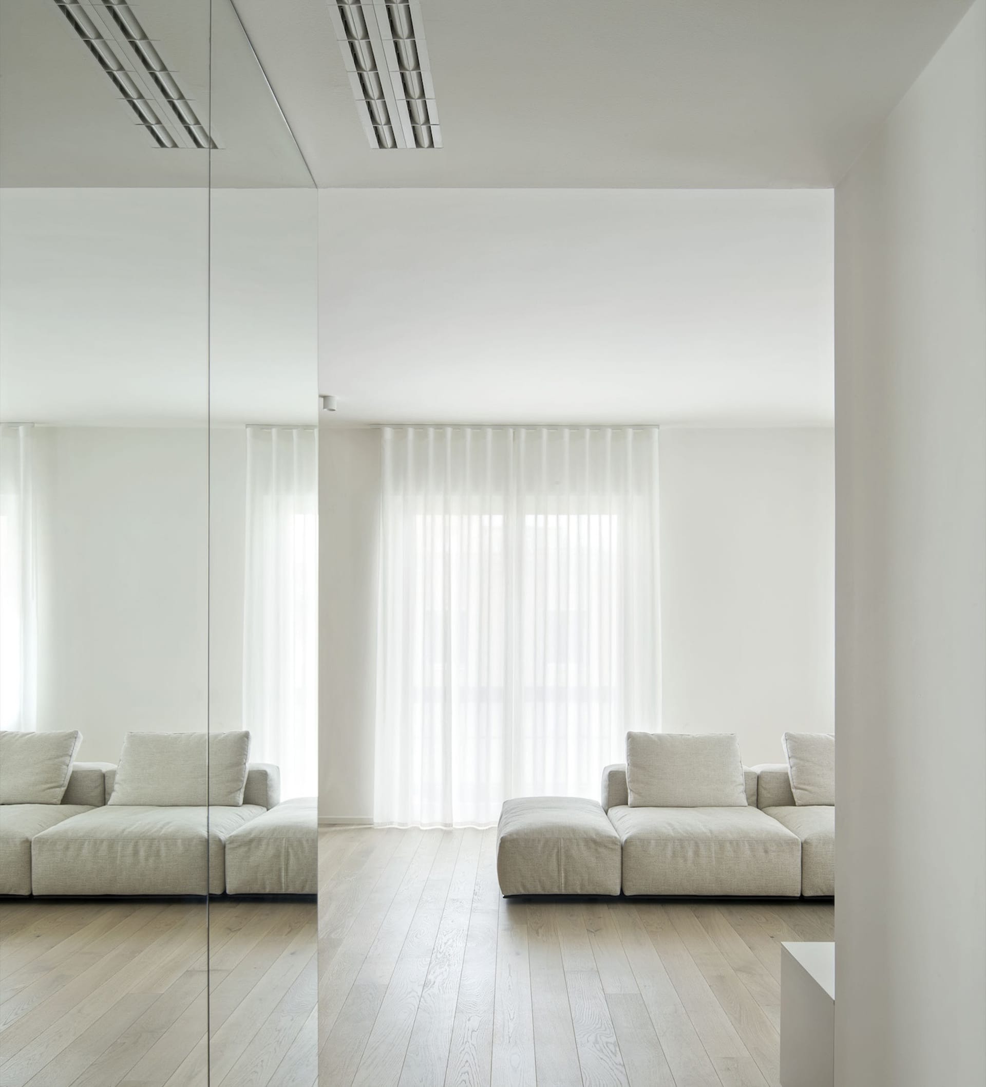 A minimalist living room with a white curtain