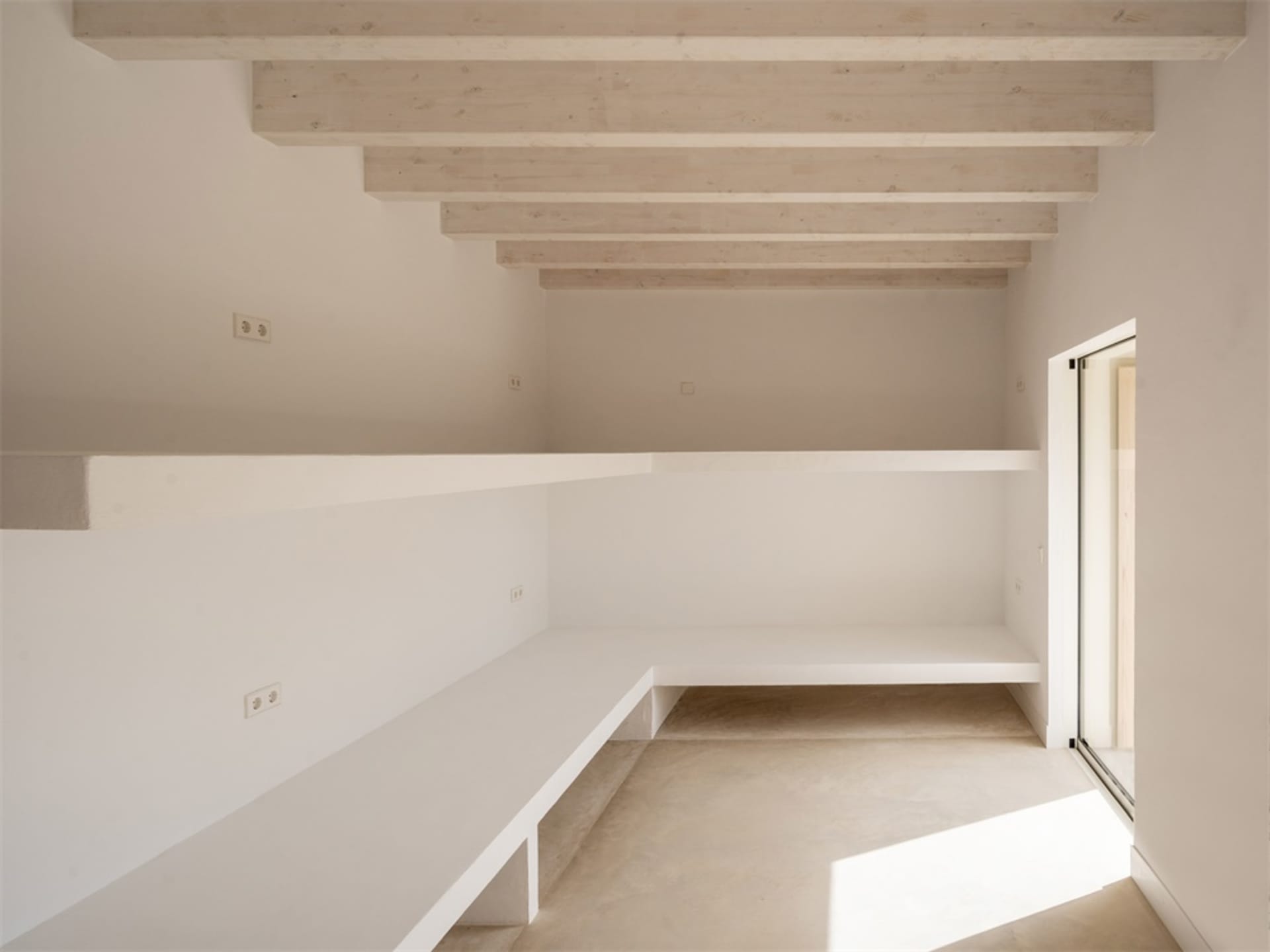Modern minimalist interior design showcasing a concrete residential closet with white shelving.
