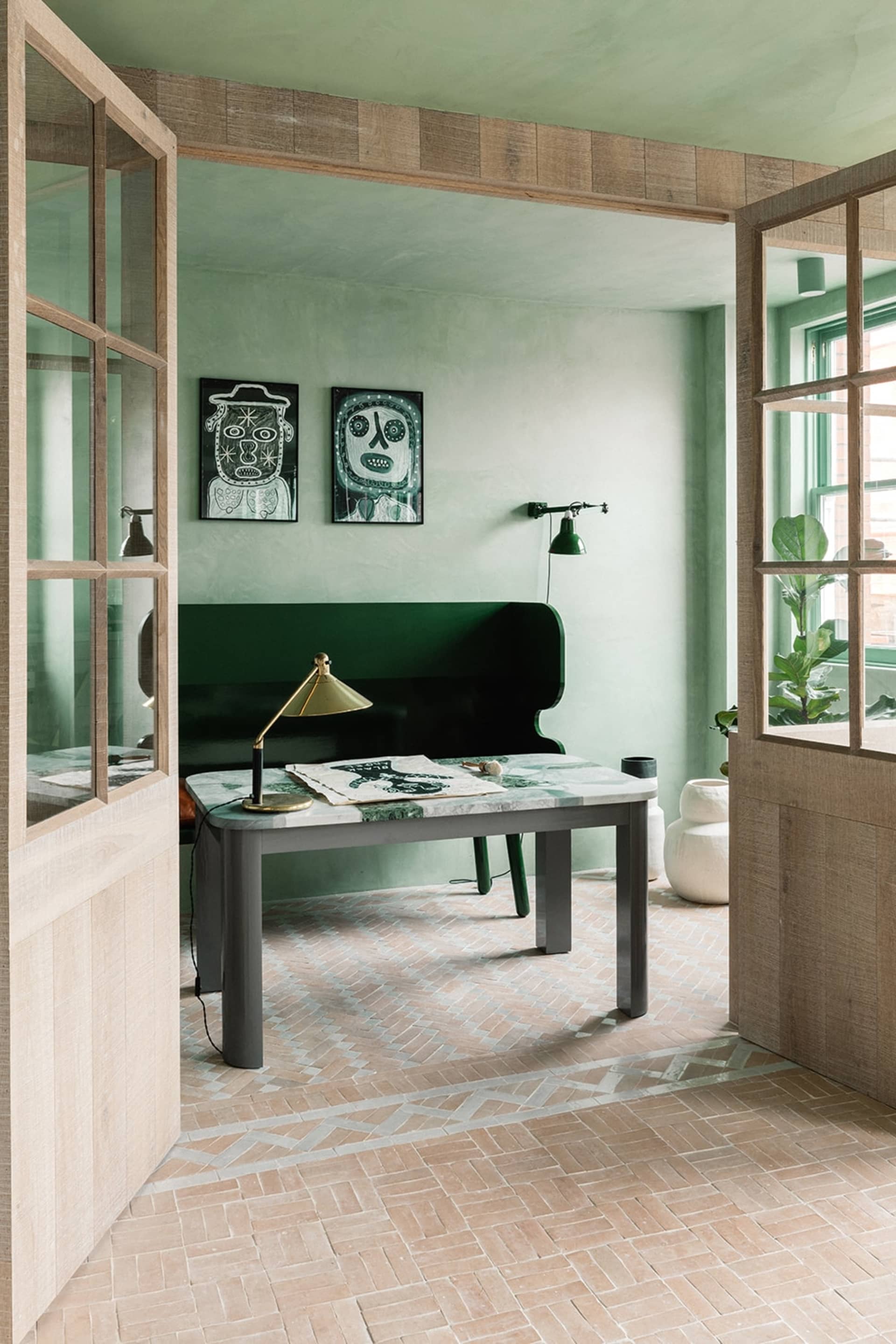 Modern living room interior with a marble tabletop desk, wooden dashboard, and concrete walls.