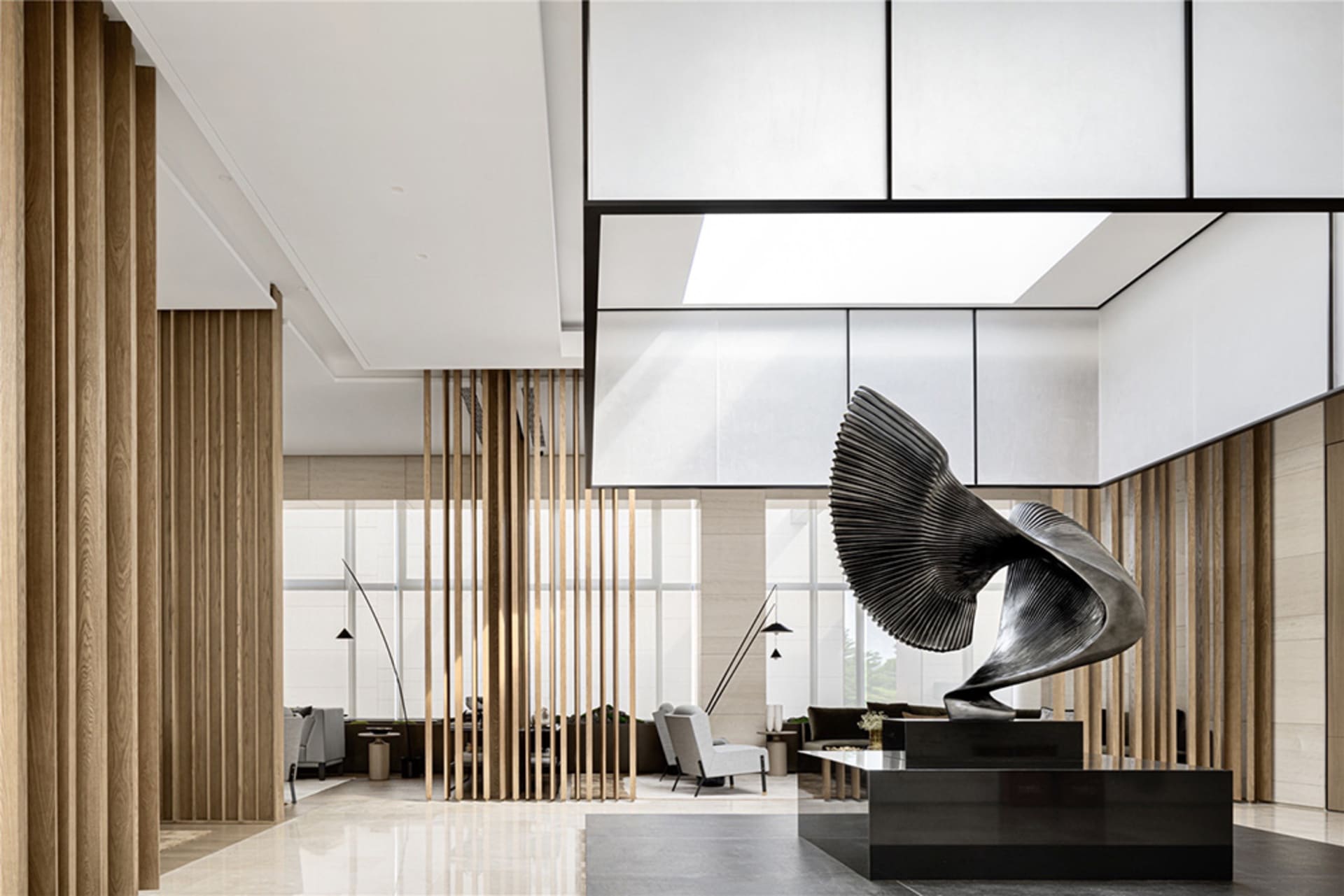 A modern lobby featuring a metal sculpture with large wings.