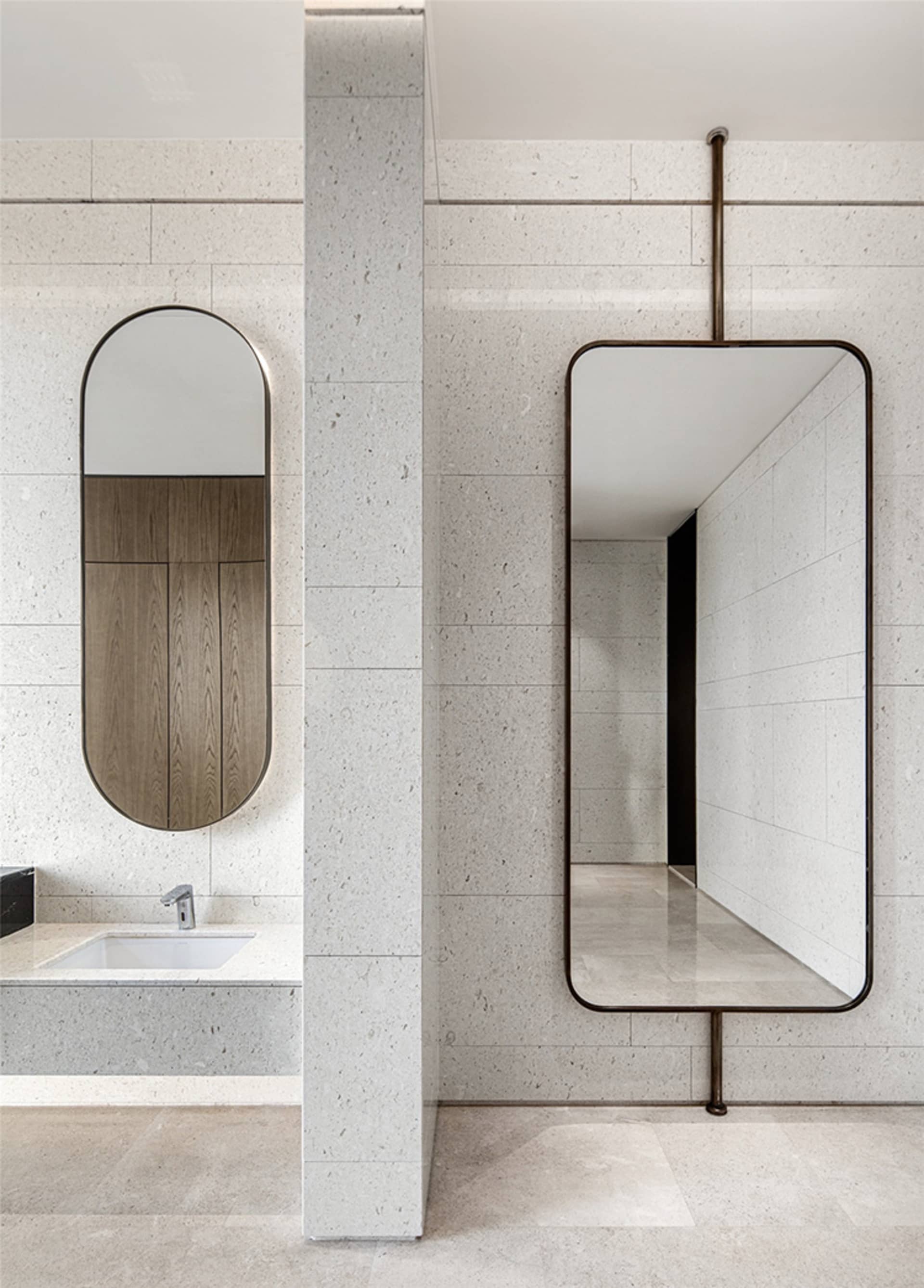 A modern minimalist bathroom featuring concrete walls and a sink