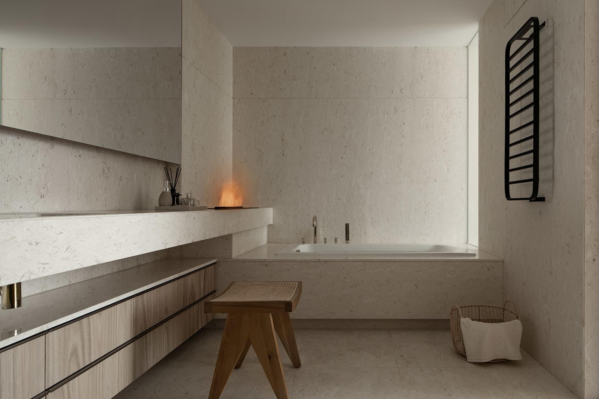 Modern minimalist bathroom with wooden stool, marble counter, and tub.