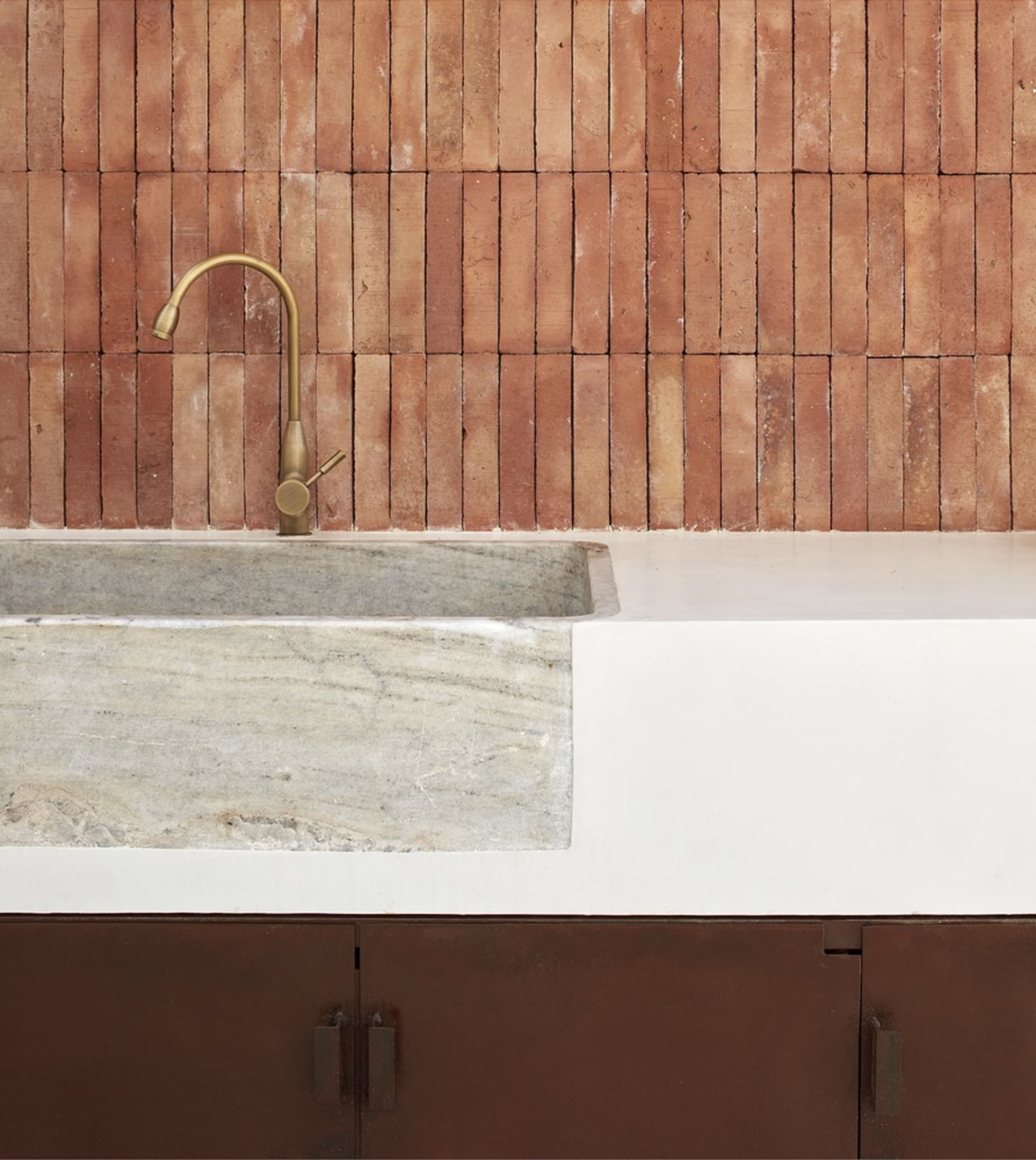 Minimalist kitchen with industrial-style metal faucet and concrete stone sink