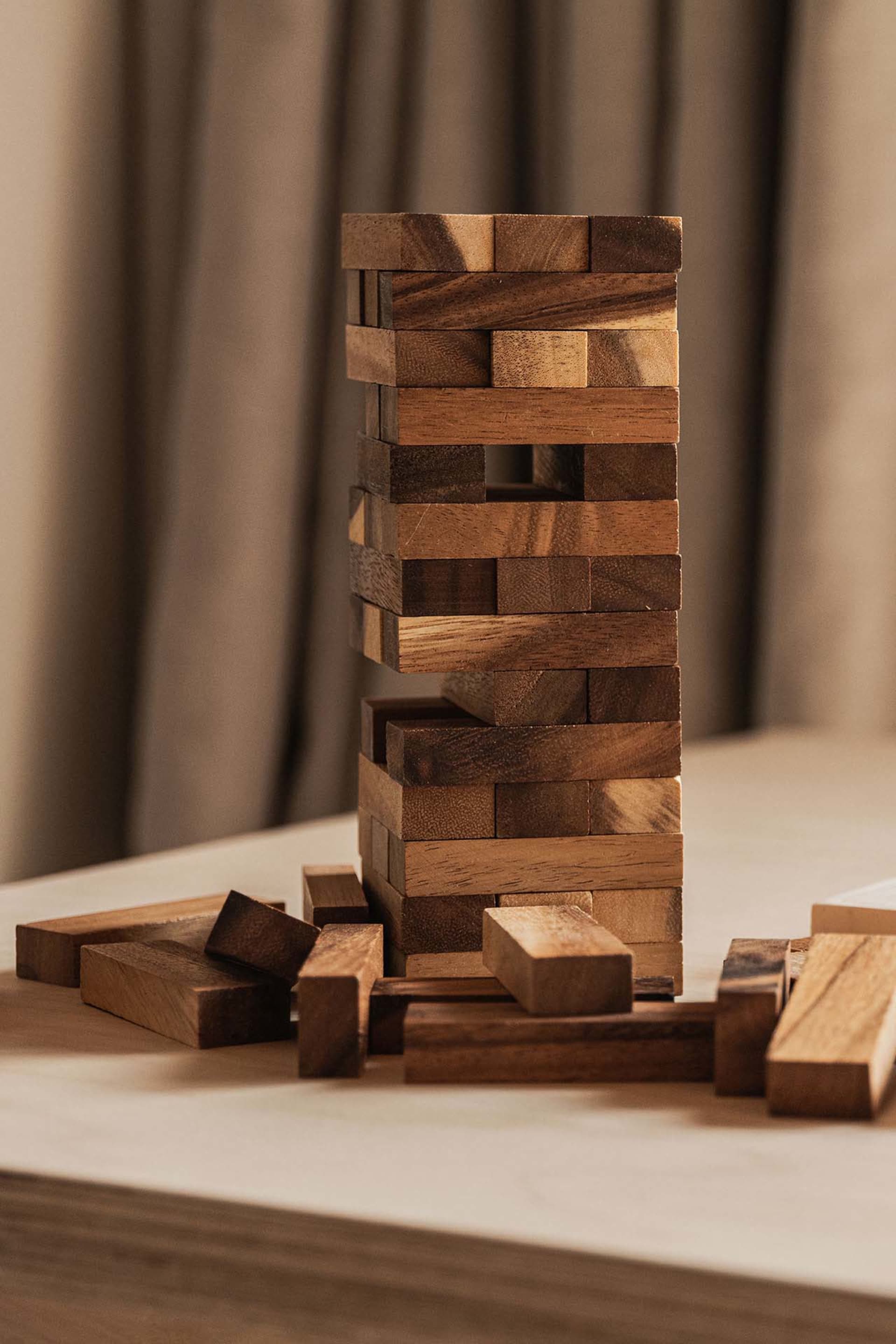 Wooden blocks stacked in a tower formation on a table.