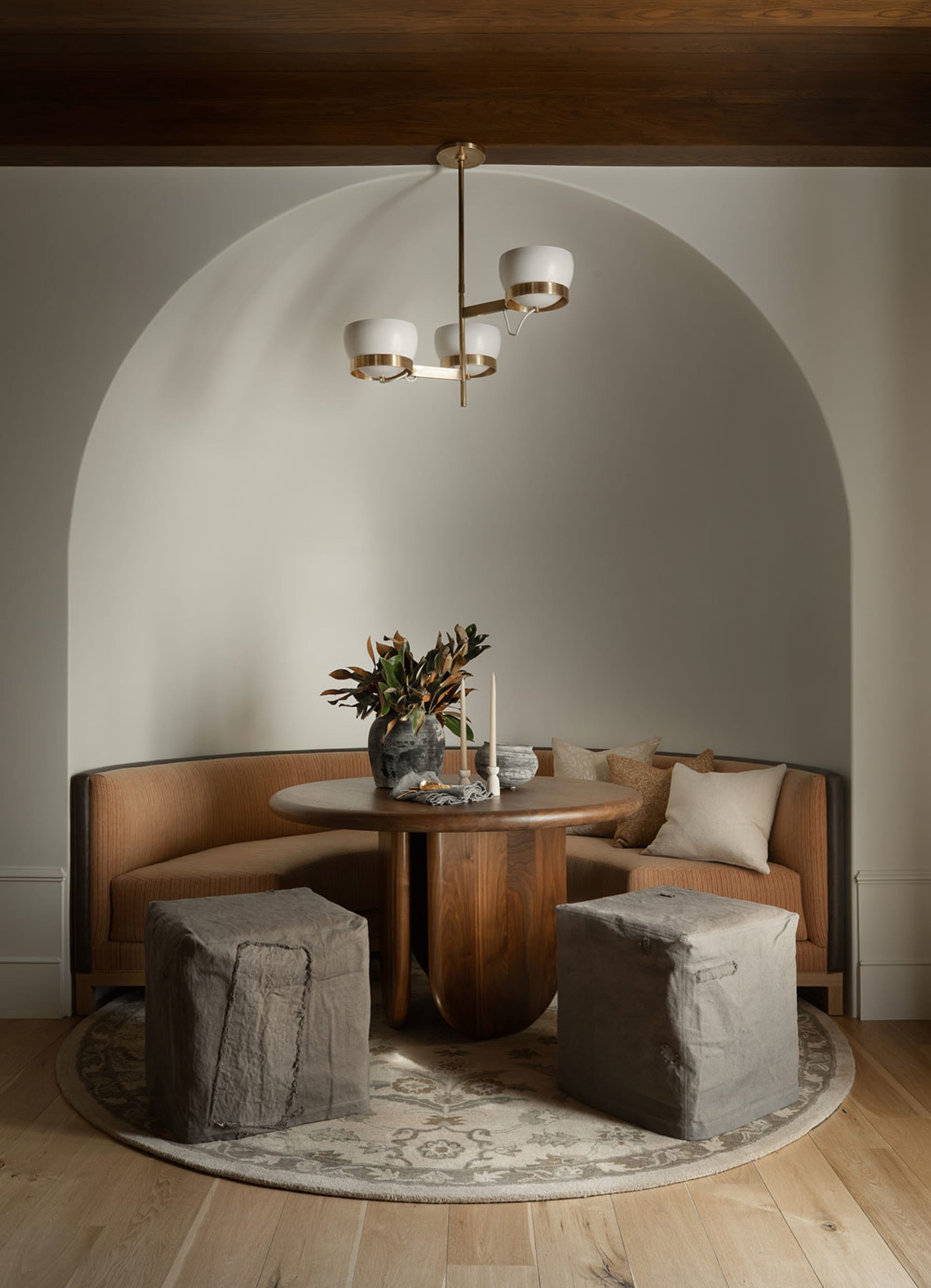 A cozy, curved seating arrangement with a wooden table in a dining room setting.