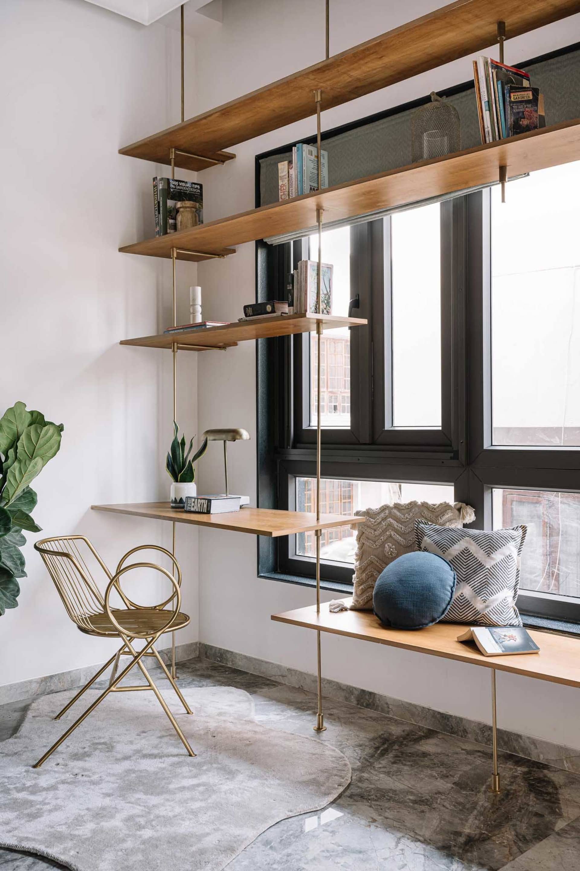 Industrial-style residential room featuring wooden shelves, metal chair, and fabric cushions.