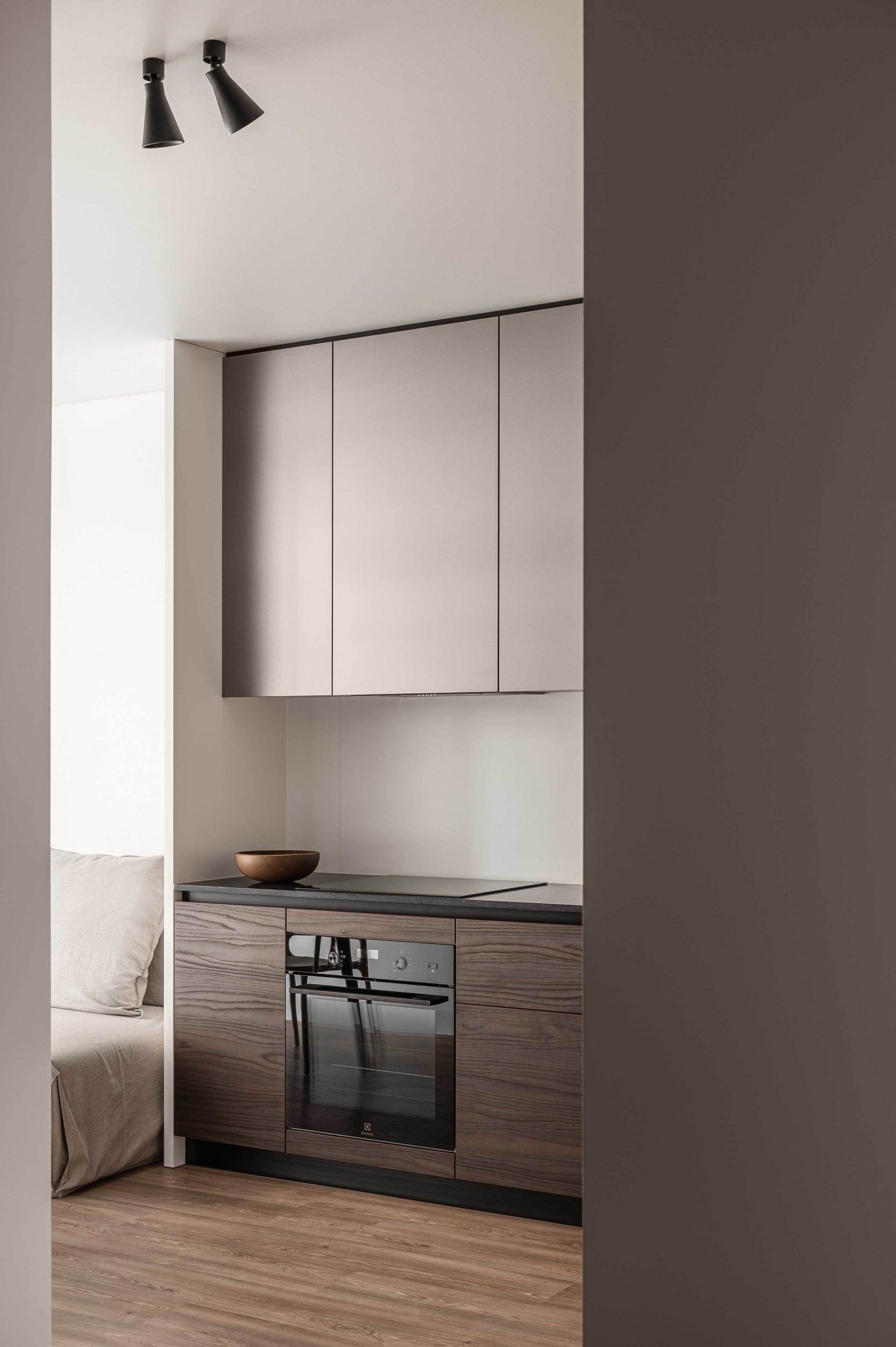 A modern kitchen with laminate finish featuring a sleek countertop, minimalist design, and compact space.