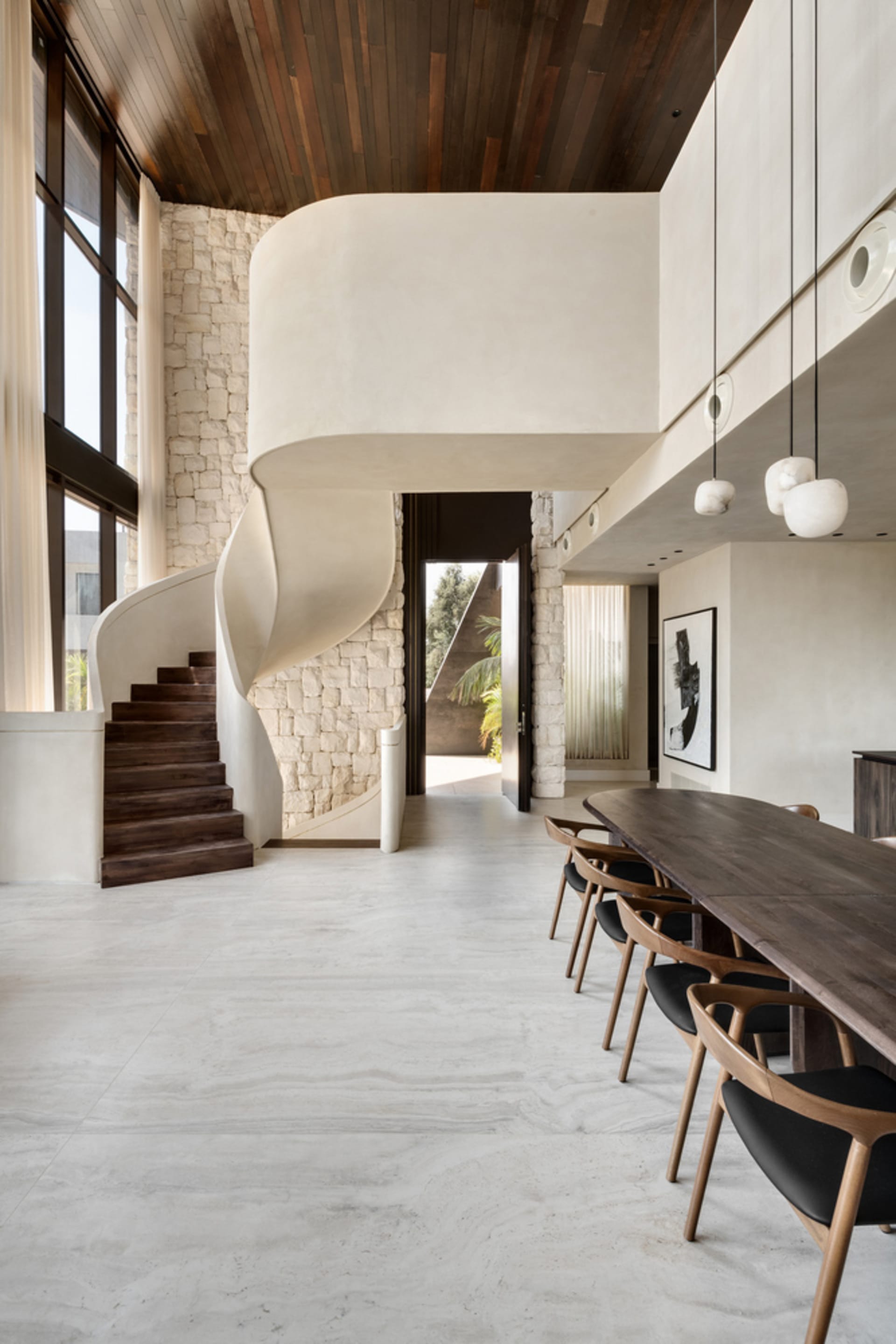 A modern residential interior featuring concrete floors and walls.