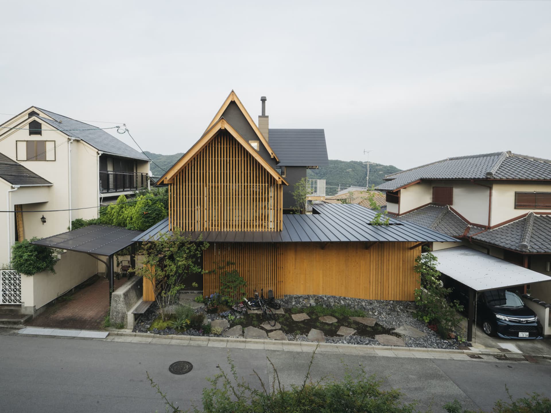 A modern residential house with wood and metal exterior features.