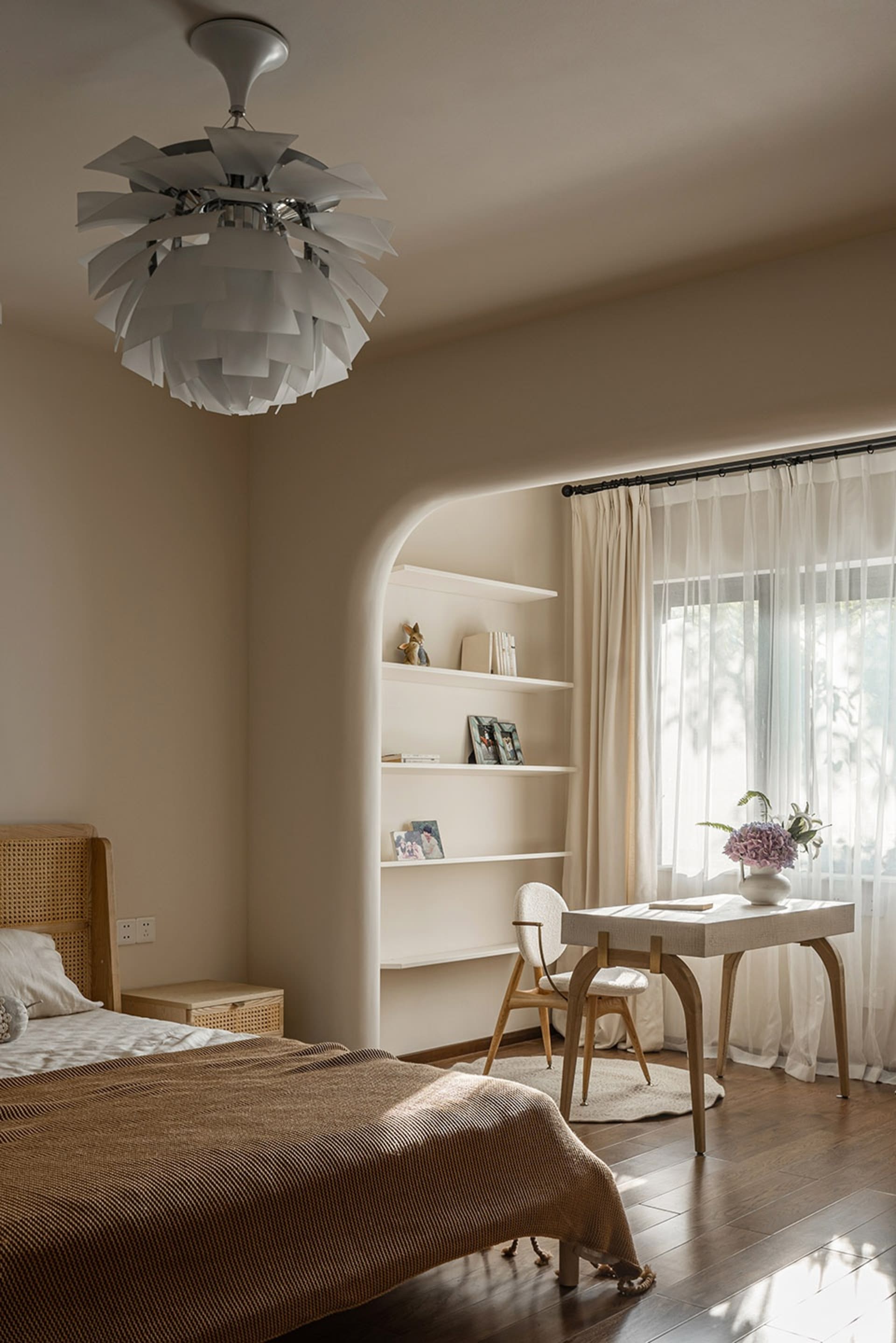 Modern bedroom featuring wooden furniture, white curtains, and a large window allowing natural light to enter.