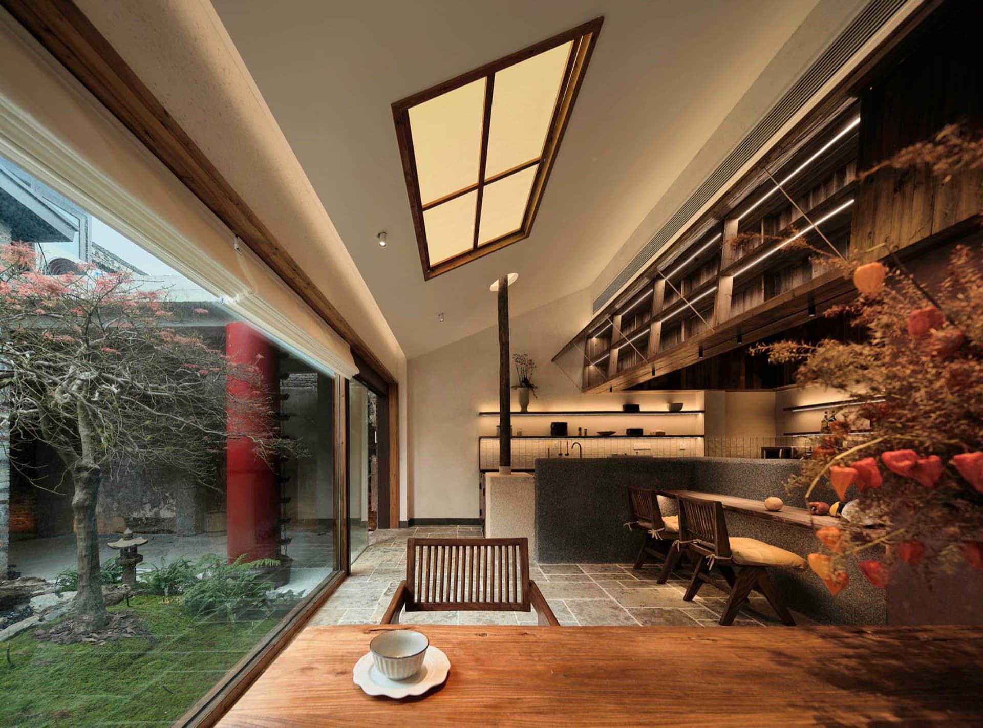 Open kitchen and dining space with a warm atmosphere, natural light, and casual dining setup