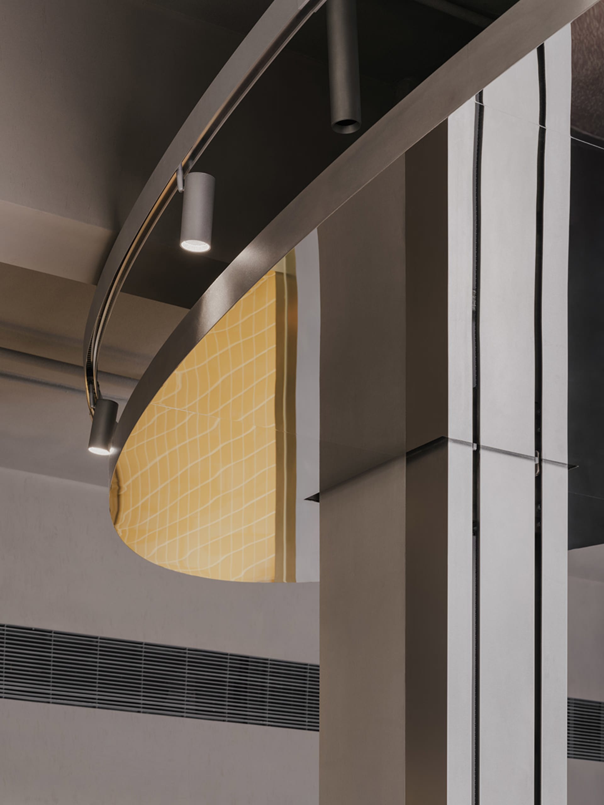 Modern lobby with a metal staircase, two side lights, and a contemporary design