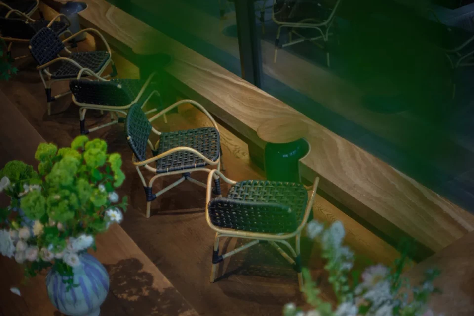A room with multiple wooden chairs in various positions, creating a warm and inviting atmosphere for relaxation and socializing