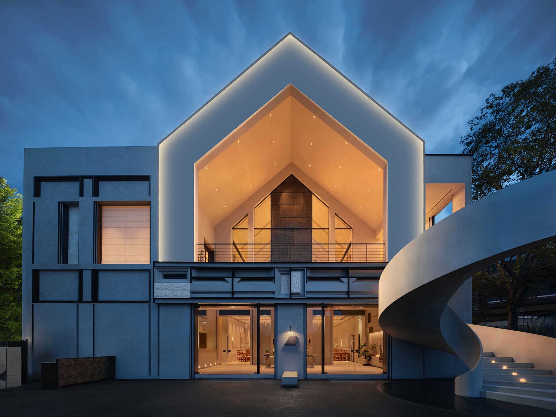 A modern building with a mix of concrete and glass elements, featuring multiple rooms and windows, with a sleek and functional design
