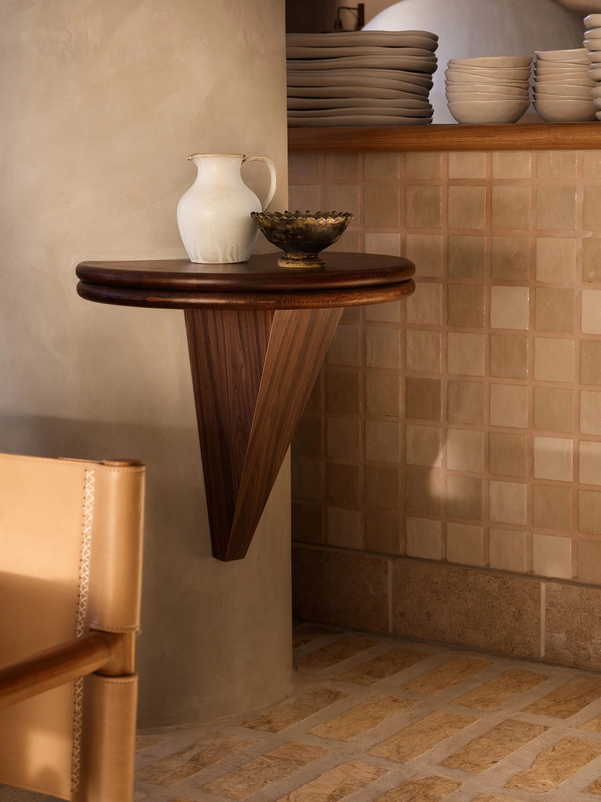 A cozy home interior with a wooden table, vase, and decorative bowls, set in a warm and inviting atmosphere
