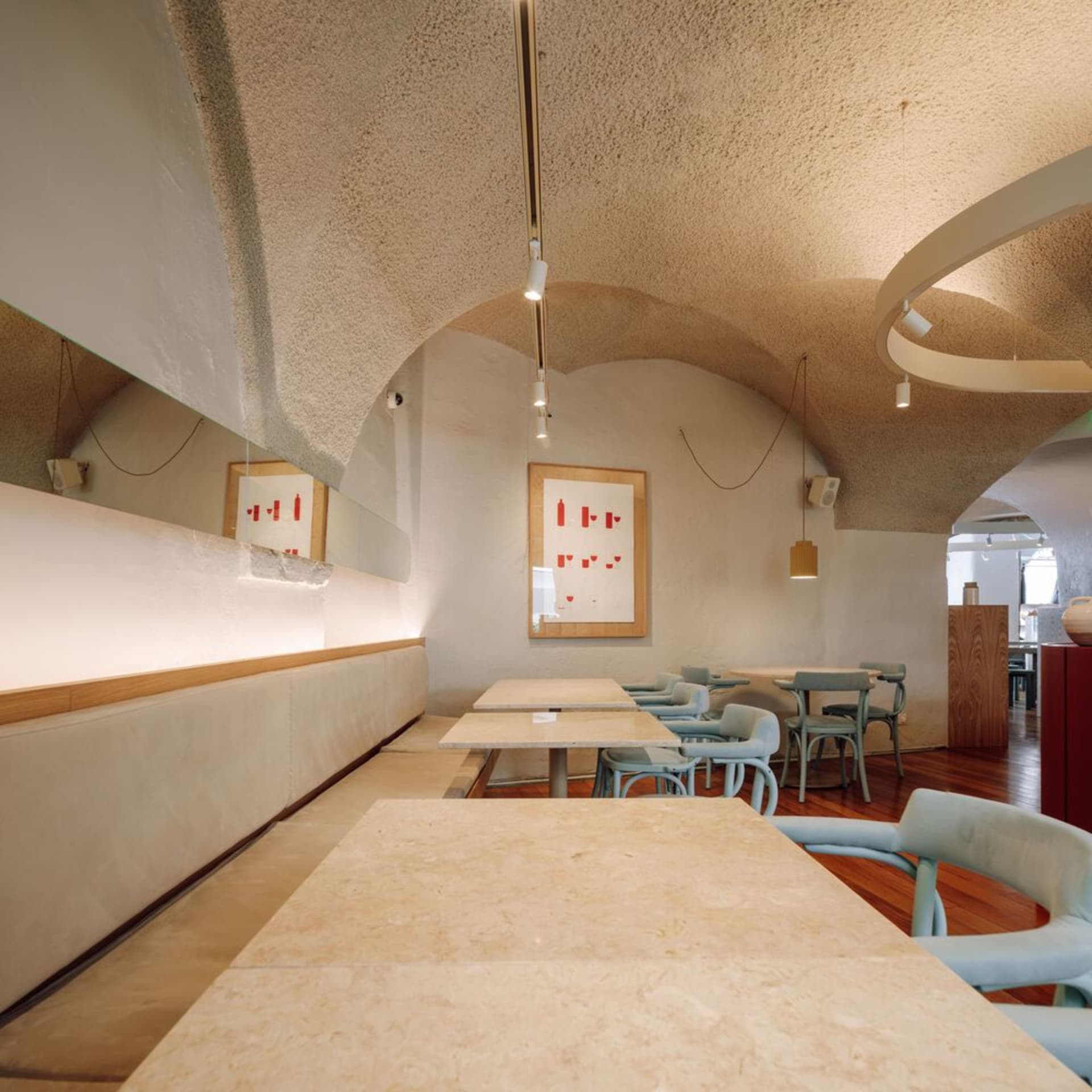 Calm and inviting restaurant interior with stone walls, wooden furniture, and a rustic atmosphere