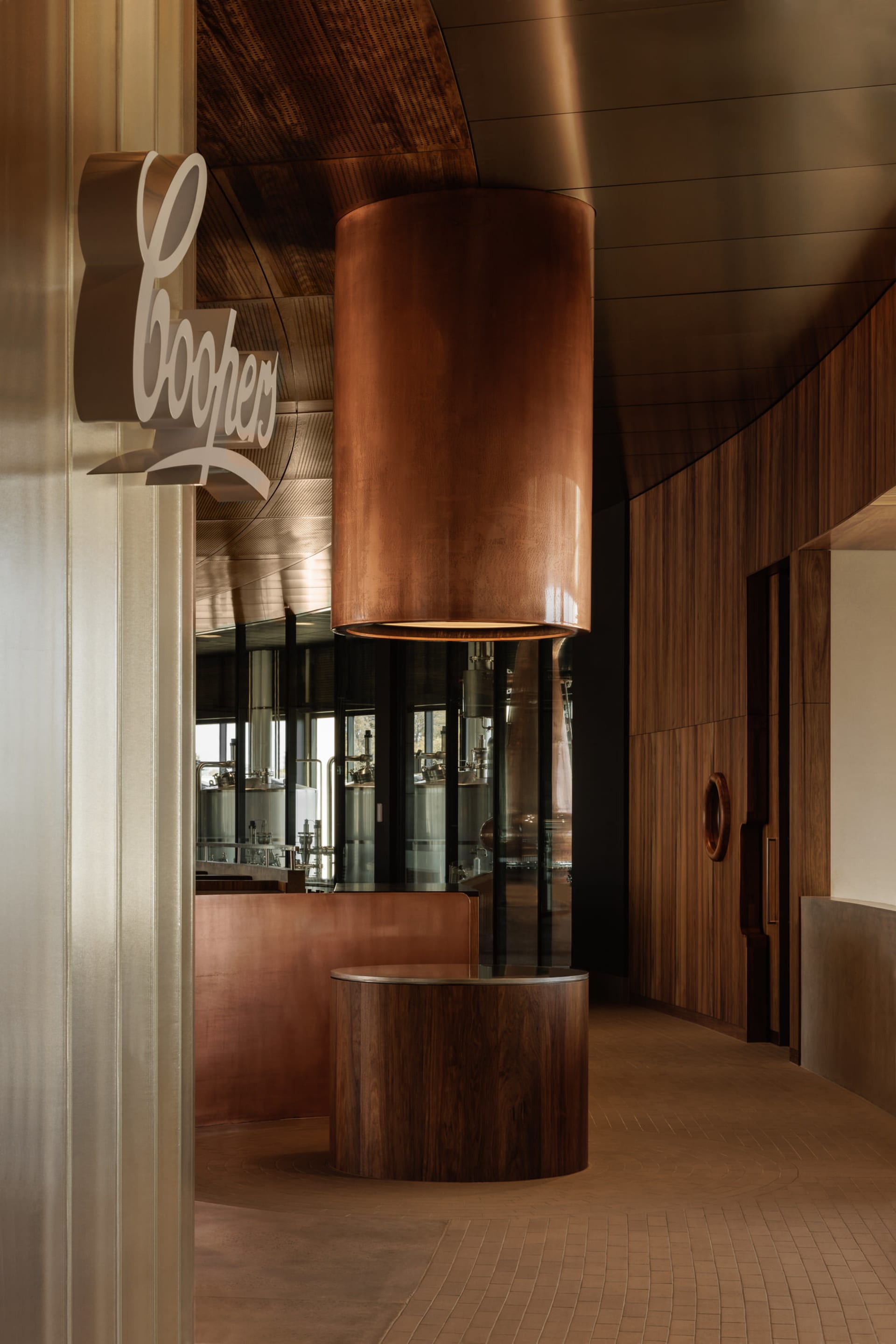 Warm and inviting interior design featuring a wooden bar area with a copper centerpiece and bottles on the countertop