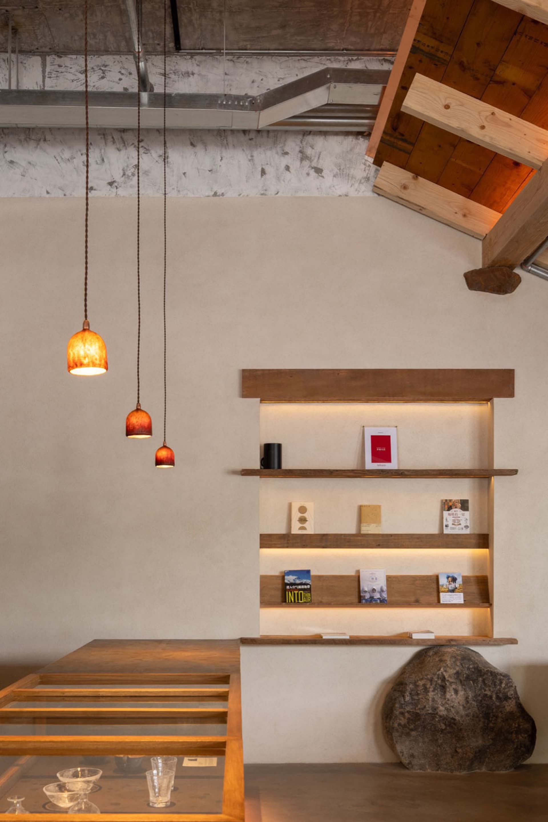 A cozy living space with a wooden bookshelf and dining table, featuring a visually appealing book arrangement and inviting atmosphere