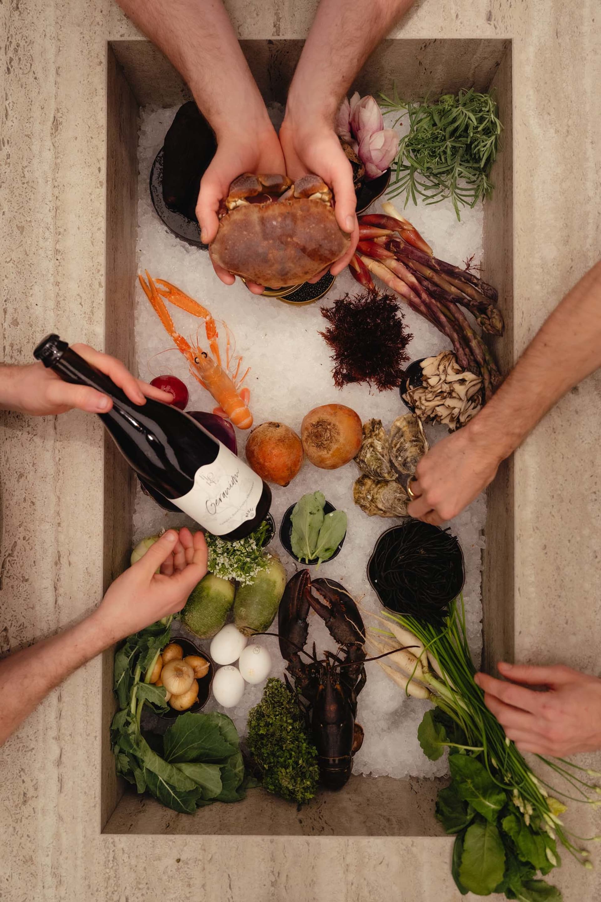 A table filled with various food items, vegetables, and beverages, suggesting a casual gathering or event with a focus on healthy eating options
