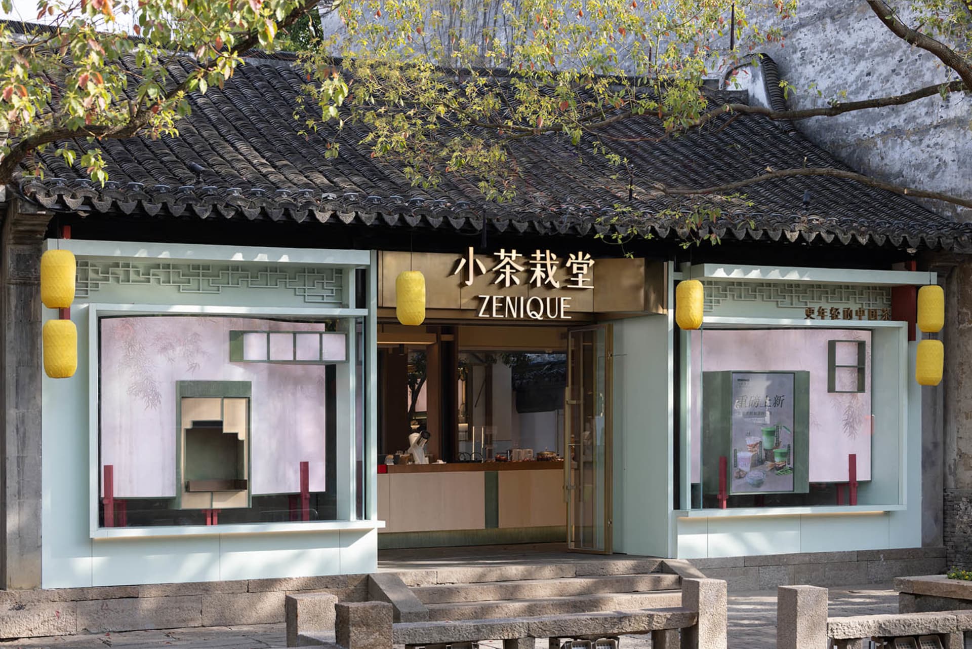 Cozy Asian restaurant with a wooden roof, stone facade, and outdoor seating with wooden tables and chairs, surrounded by people enjoying their meal