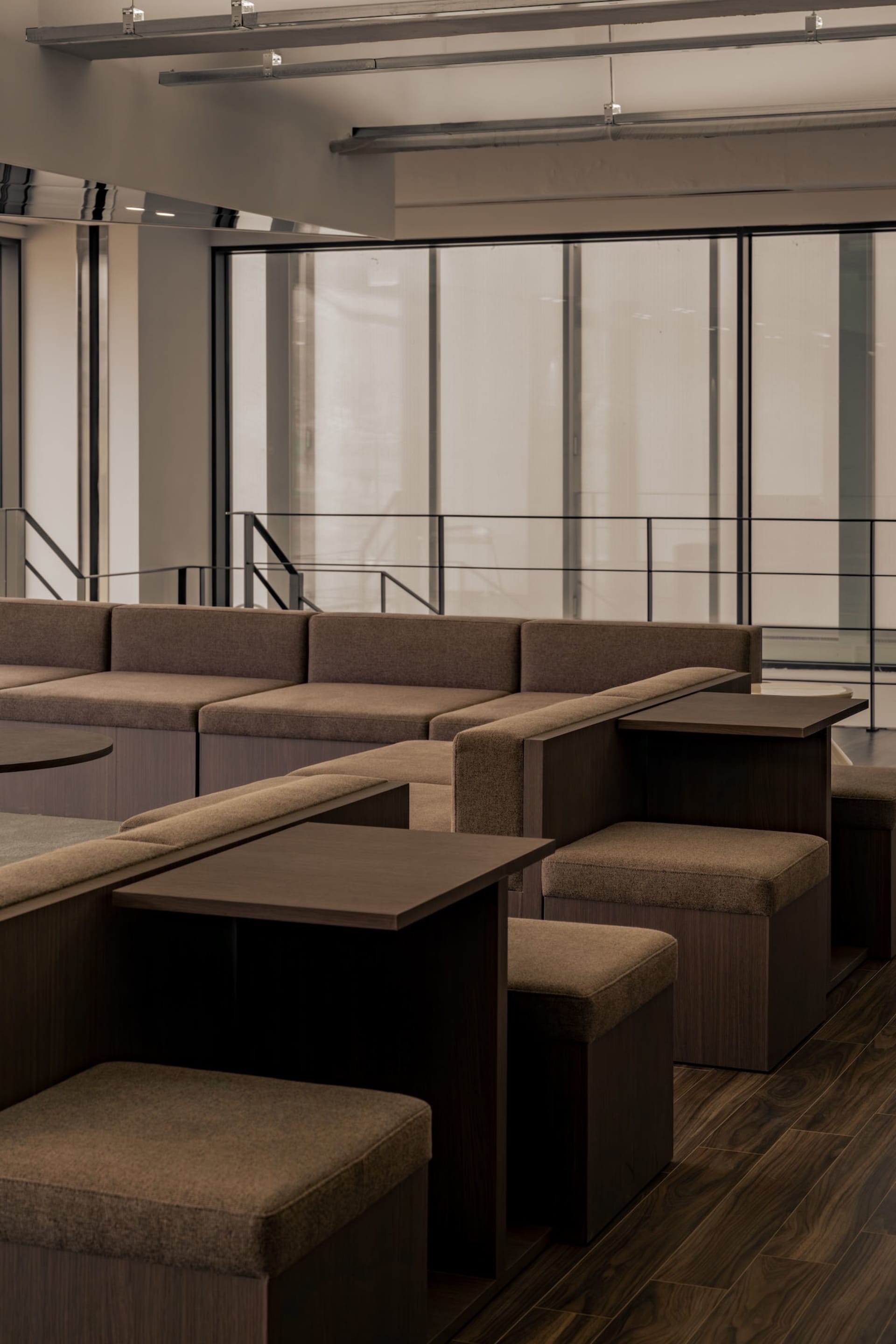 A spacious room with several couches in various positions, creating a calm and inviting atmosphere for relaxation and socializing