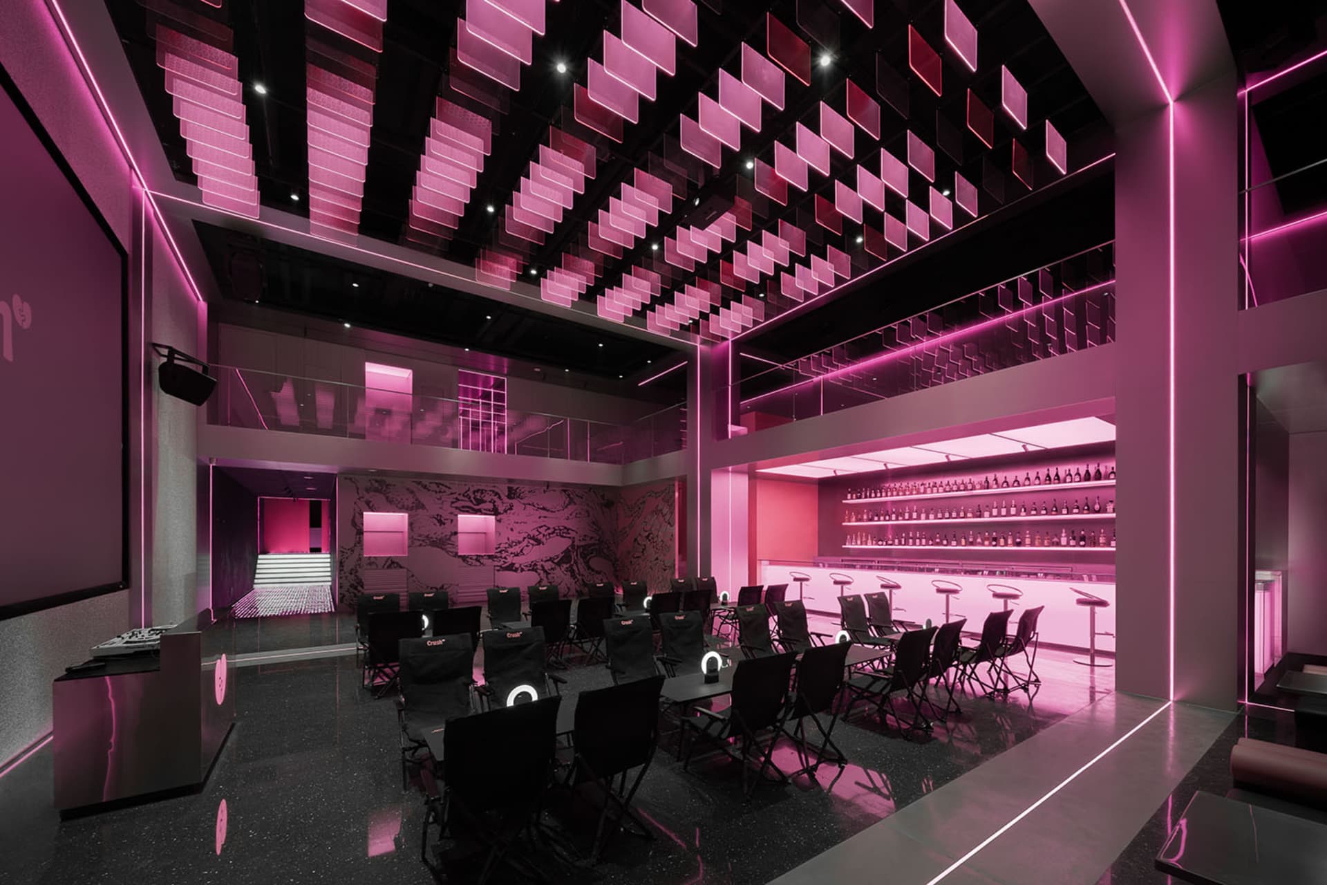 Pink-walled restaurant interior with dining tables, chairs, and table lamps