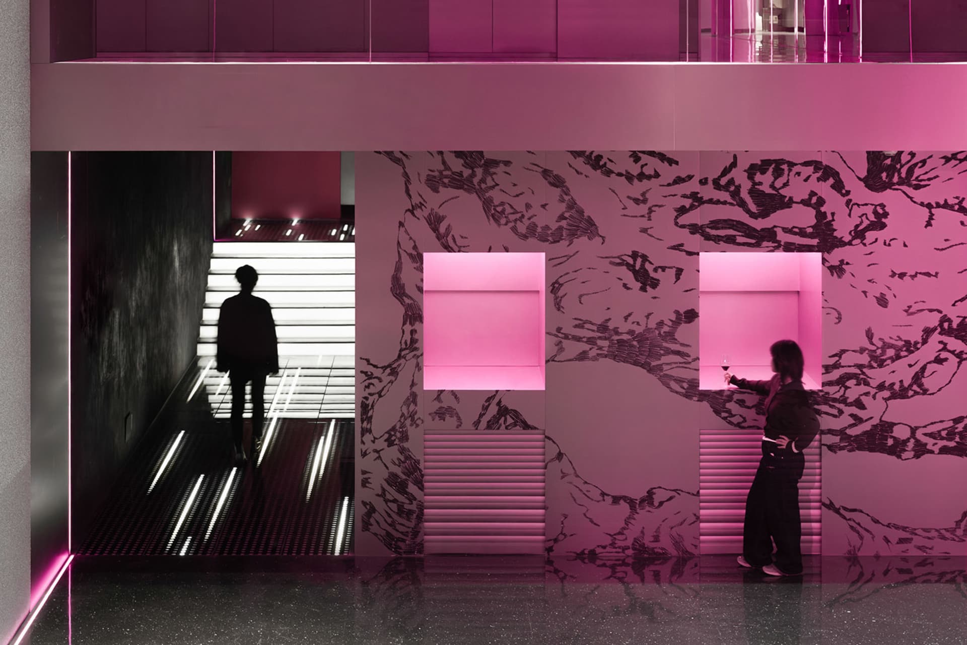 A modern interior space with a staircase, pink and white colors, and bold contrasting elements