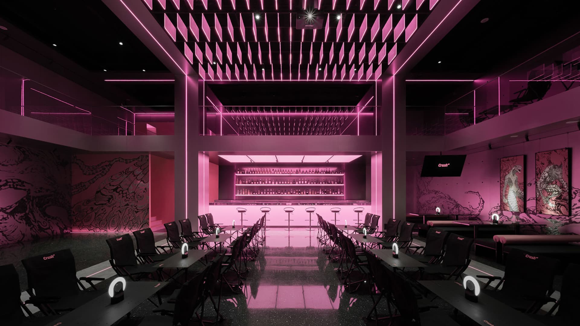 Modern restaurant interior with pink walls and flooring, featuring multiple chairs and tables in a stylish setting