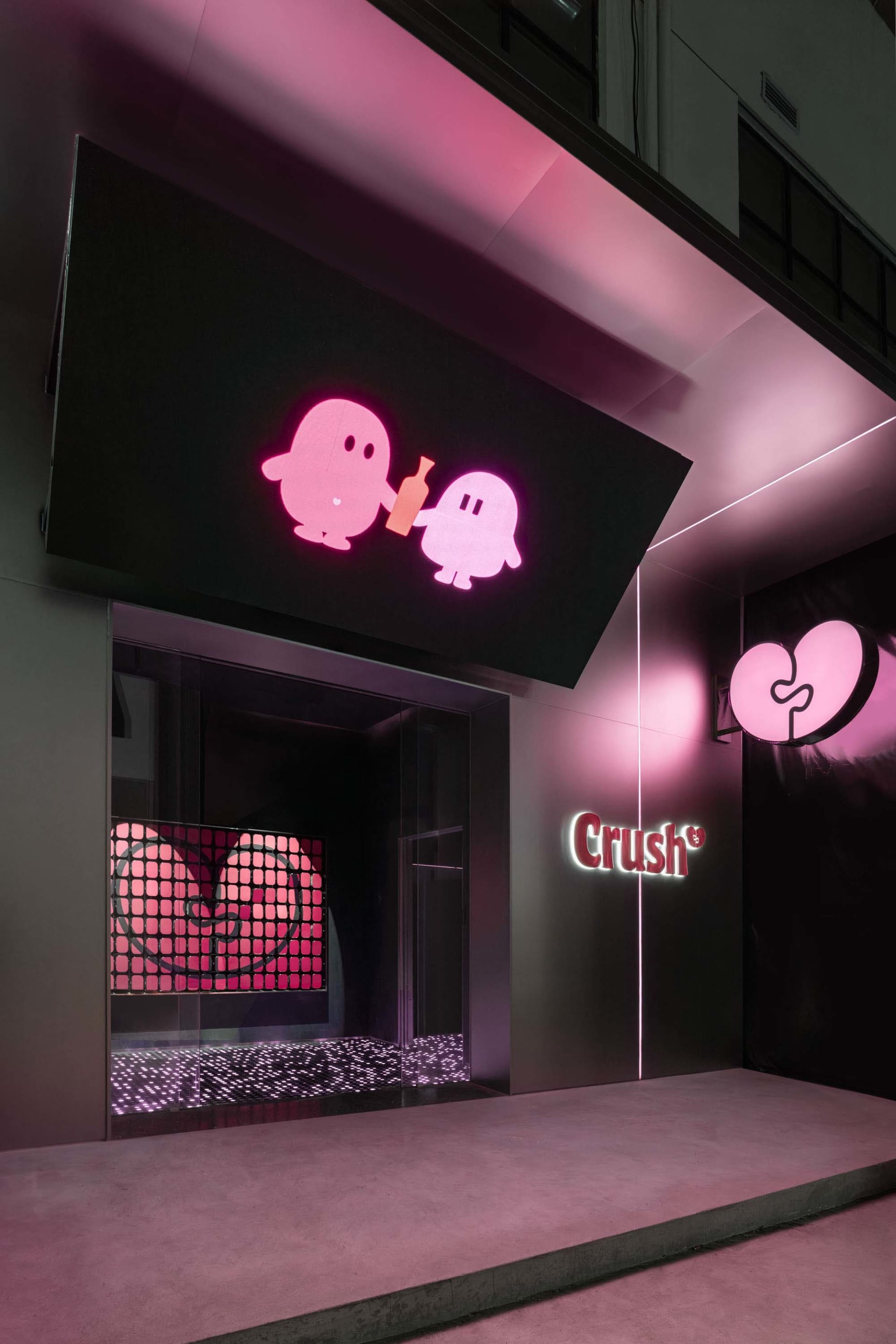 A modern retail space with pink and purple elements, featuring two large pink hearts and a vibrant atmosphere