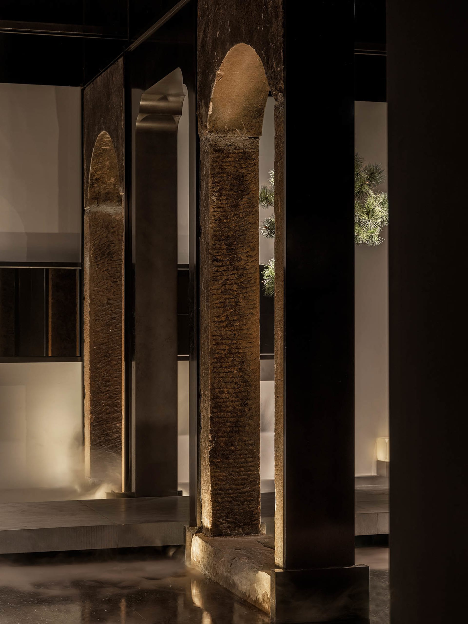 A dimly lit interior space with stone pillars and a mysterious atmosphere, inspired by ancient architecture