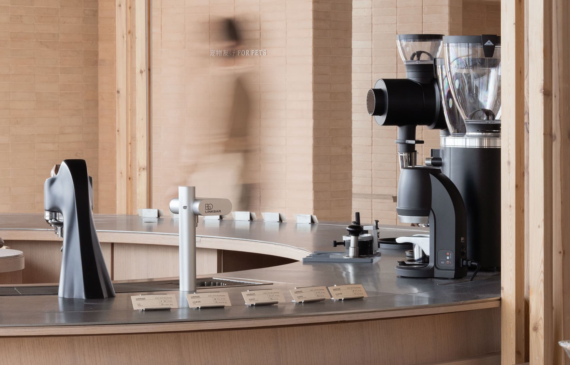A coffee shop interior with wooden countertops, two espresso machines, and a welcoming atmosphere